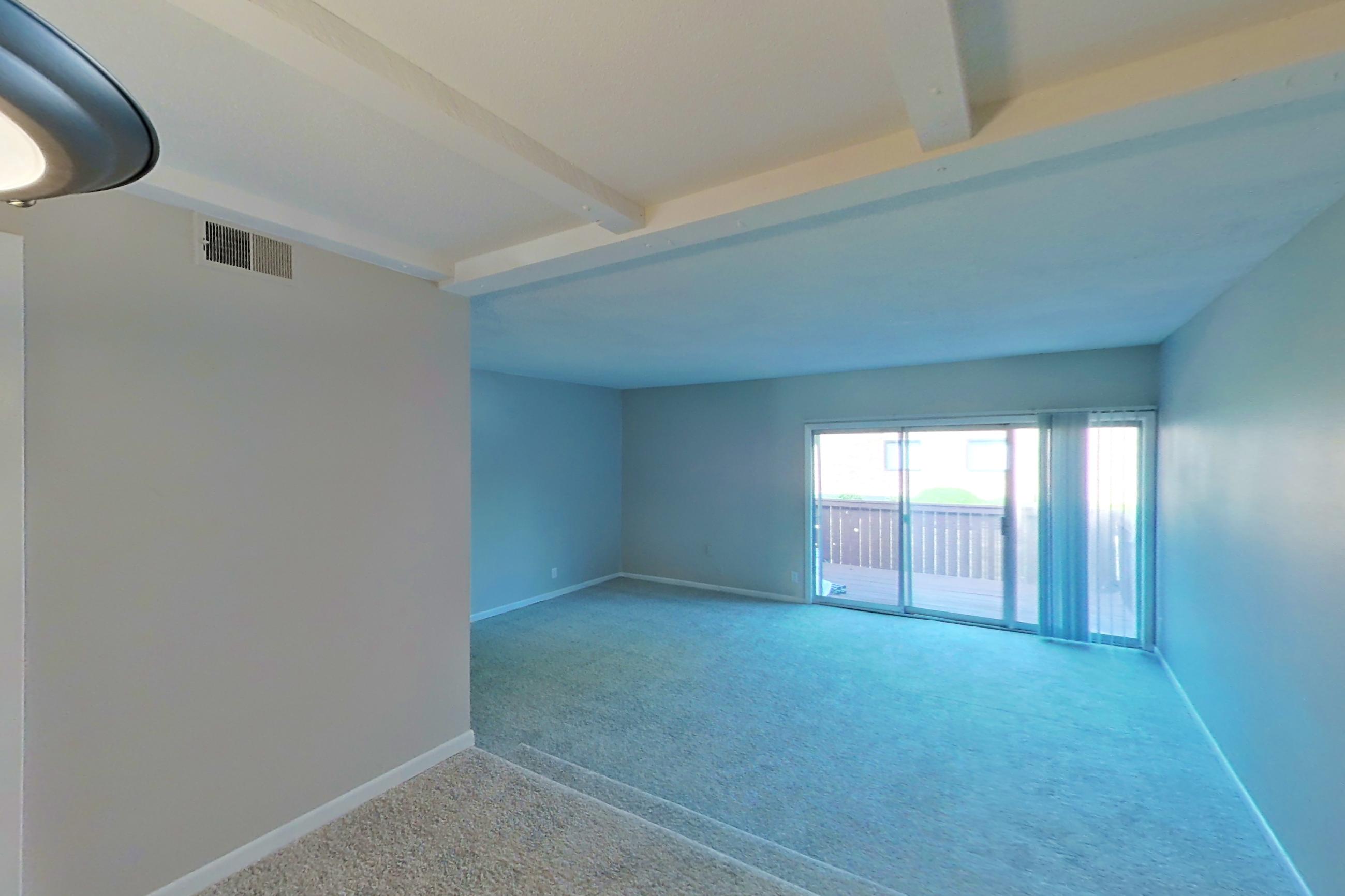 Living space with black appliances, electric range, light carpet, and oven/range, Apartment 1524C at The Life at Legacy Fountains