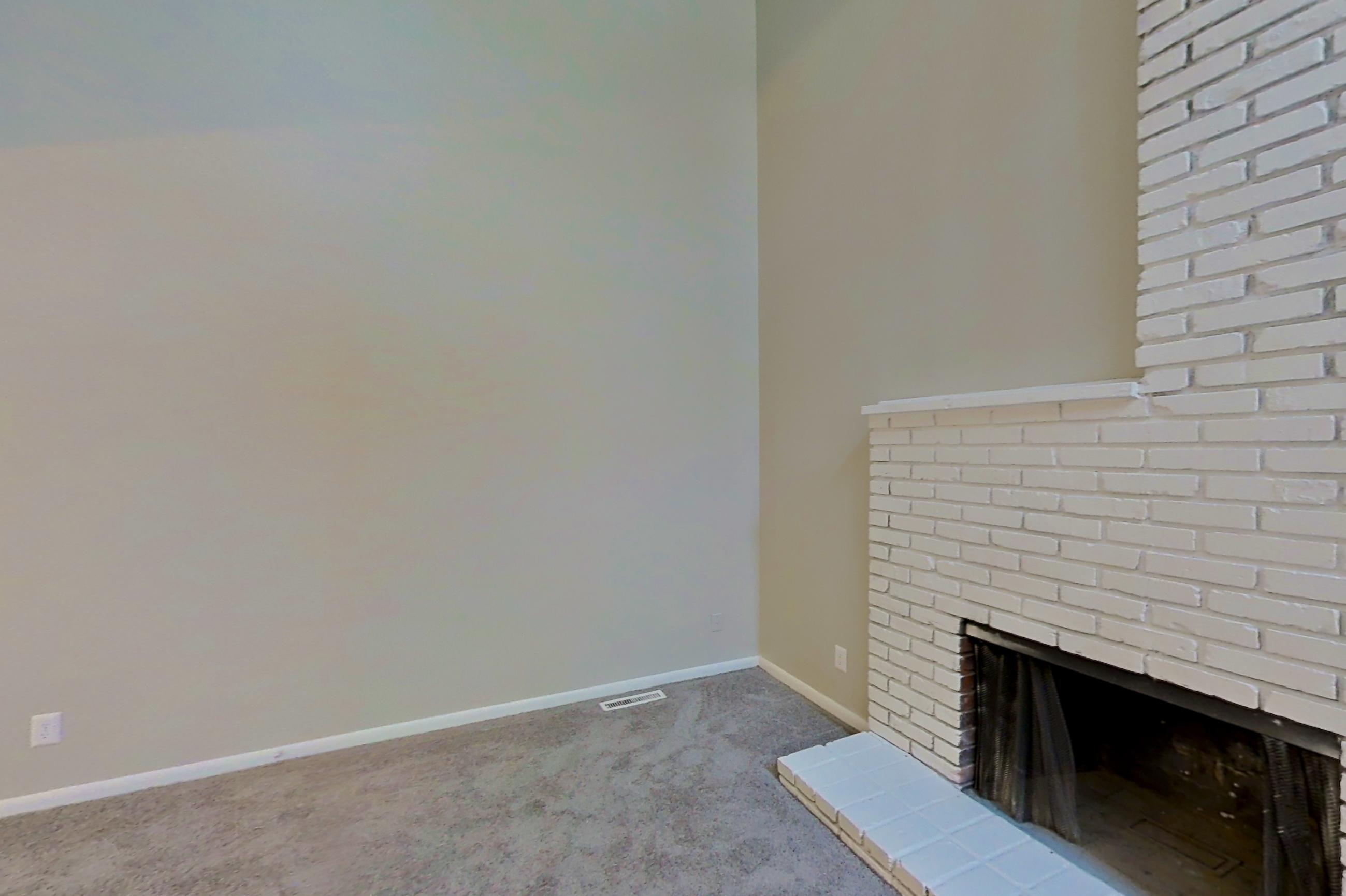 Living room with black appliances, dishwasher, fireplace, light carpet, and tile fireplace, Apartment 1415 at The Life at Legacy Fountains