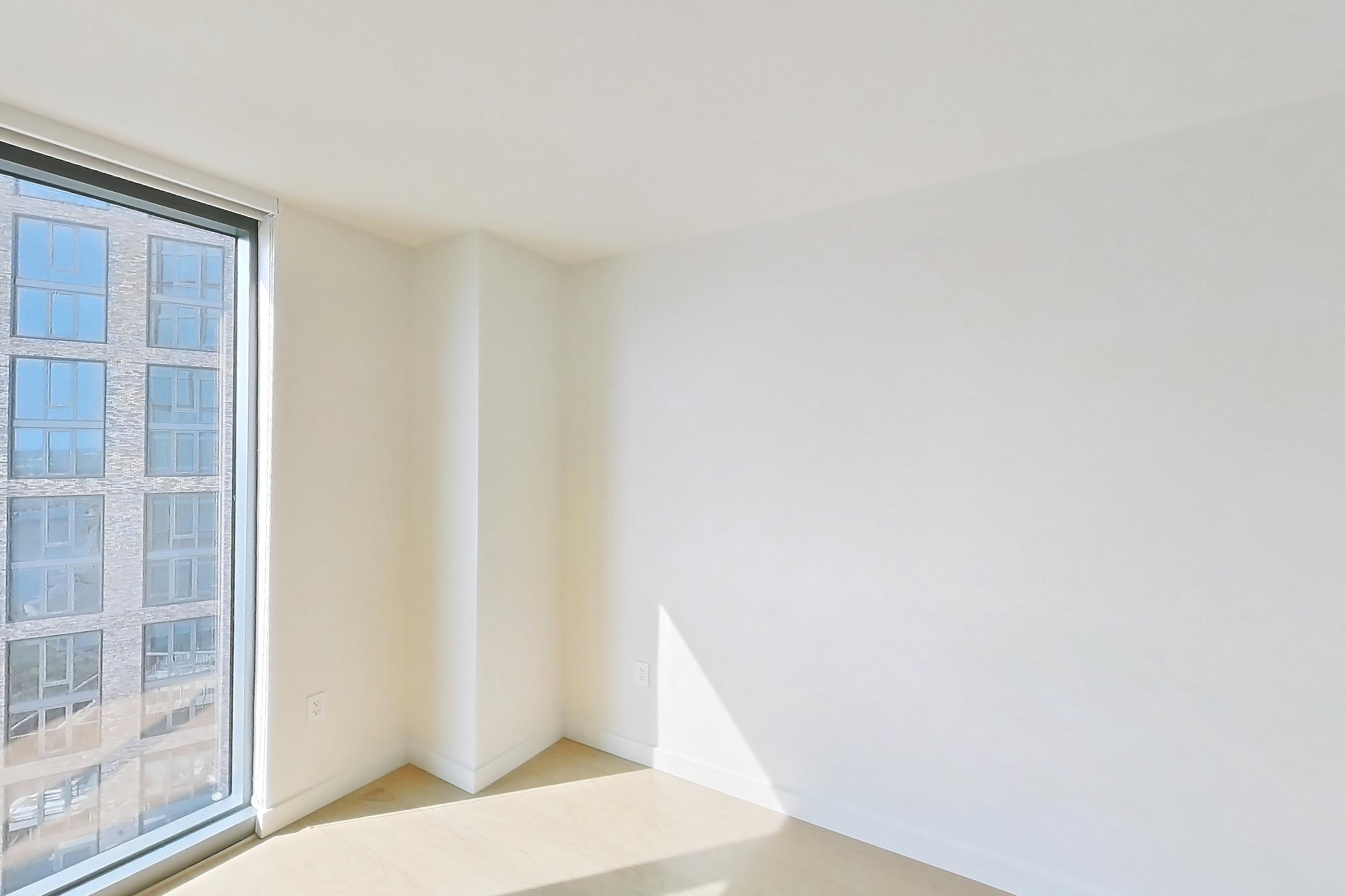 Living space with light wood-finish flooring, oven/range, and stainless steel appliances, Apartment S-1518 at Lincoln at Bankside