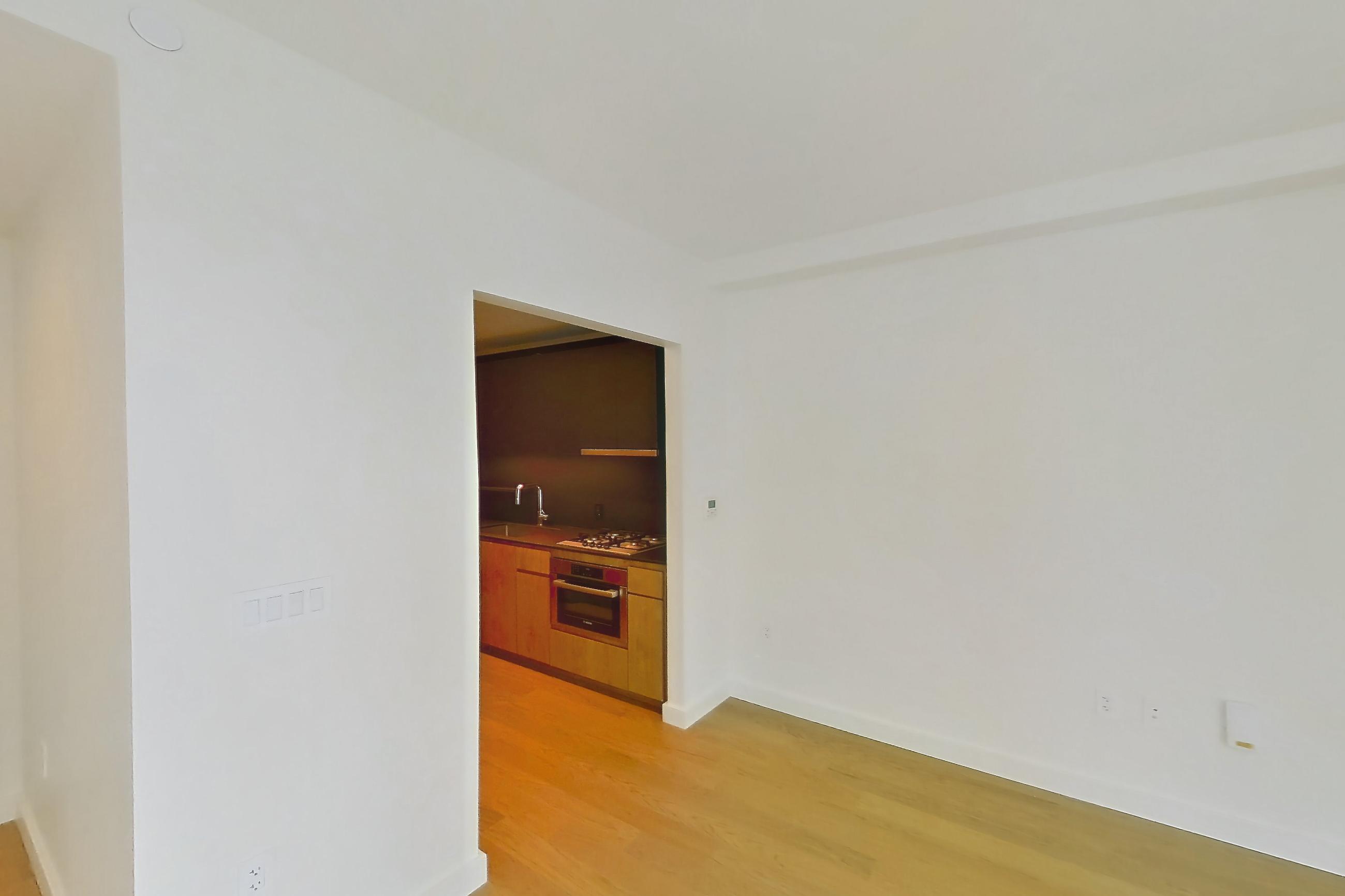 Living space with gas cooktop, light wood-finish flooring, oven/range, and stainless steel appliances, Apartment 1618 at Lincoln at Bankside