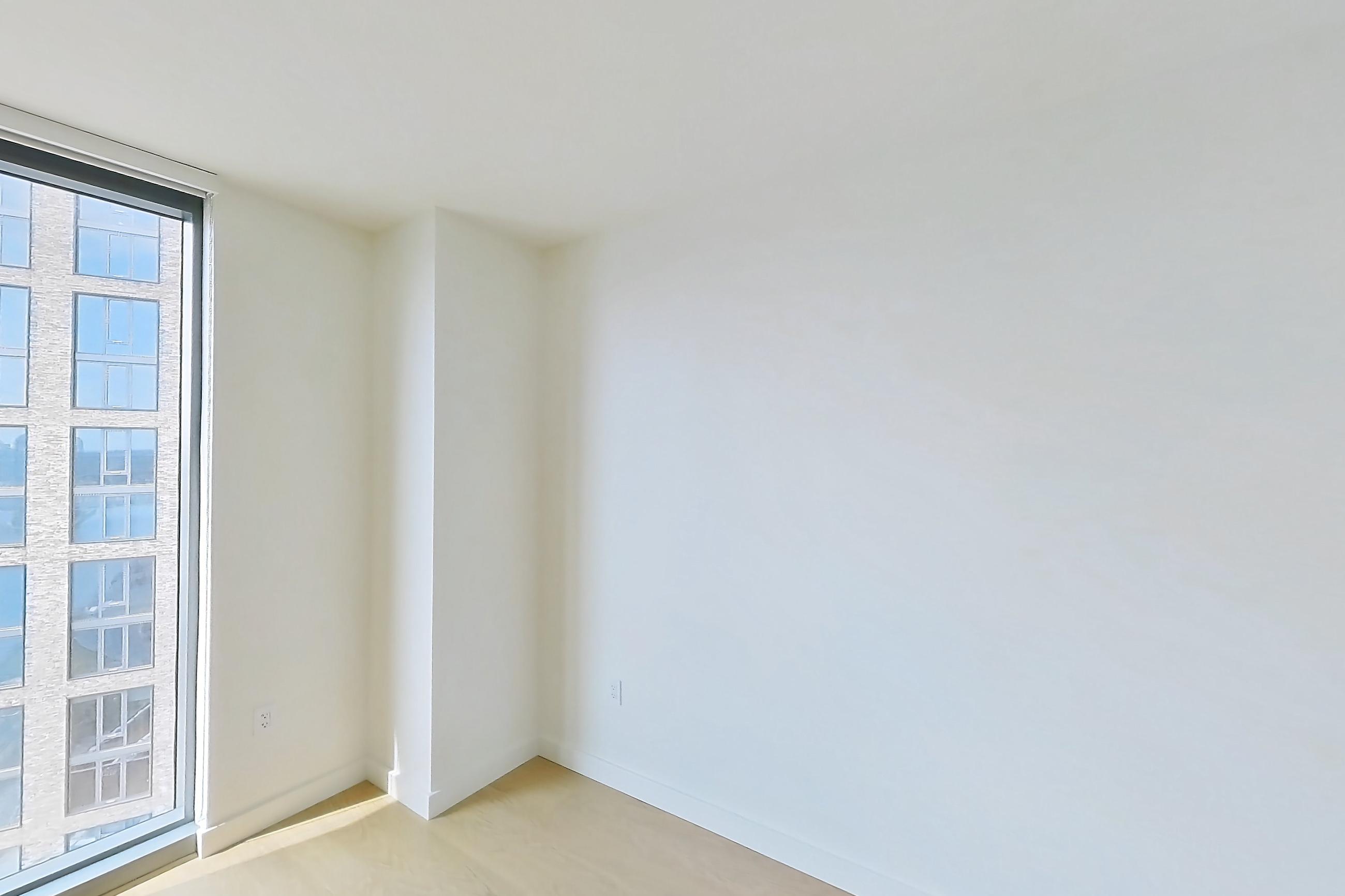 Living space with gas cooktop, light wood-finish flooring, oven/range, and stainless steel appliances, Apartment 1618 at Lincoln at Bankside