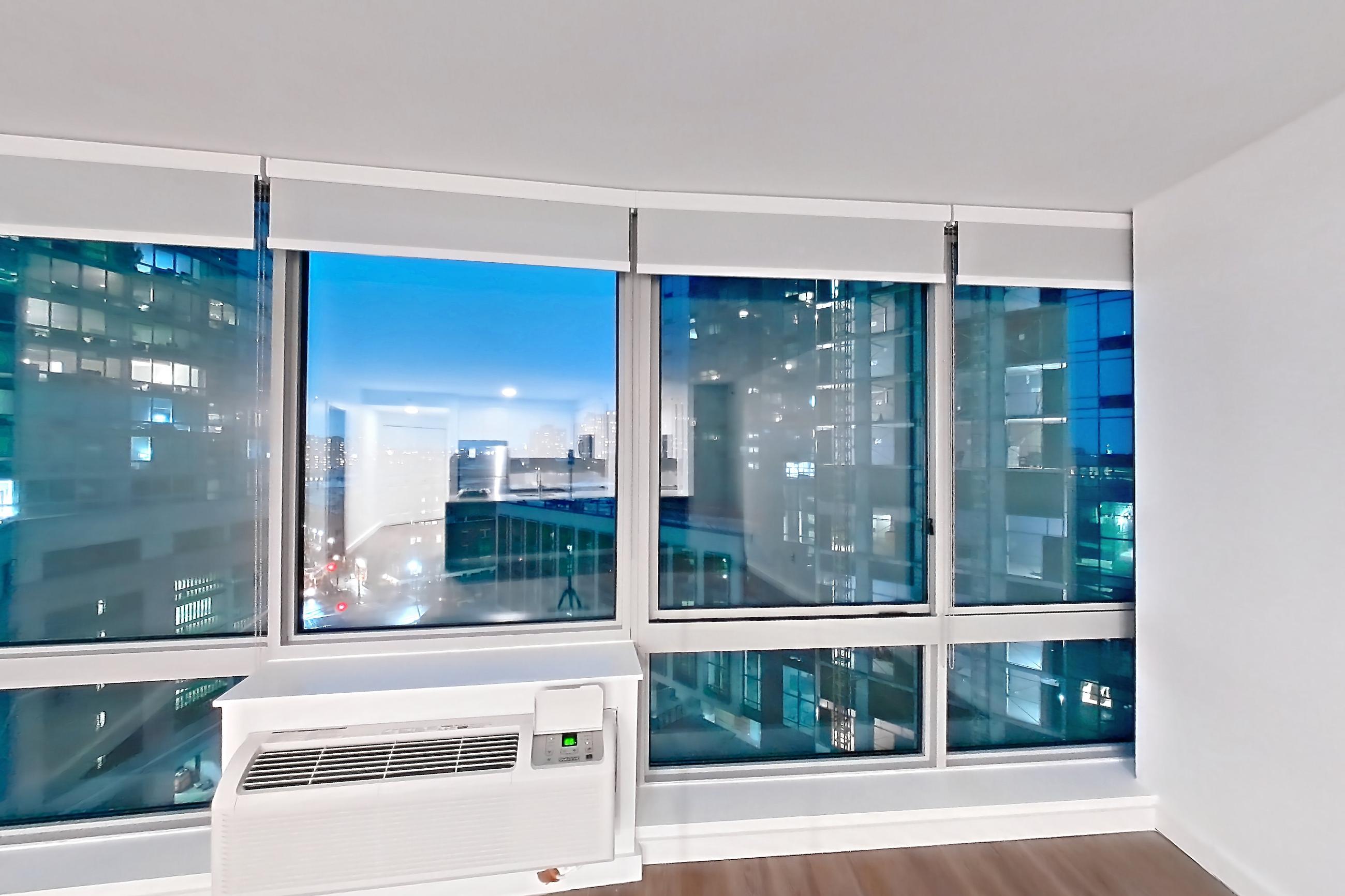 Living room with dark wood-finish flooring, Apartment LT-E1007 at Liberty Towers