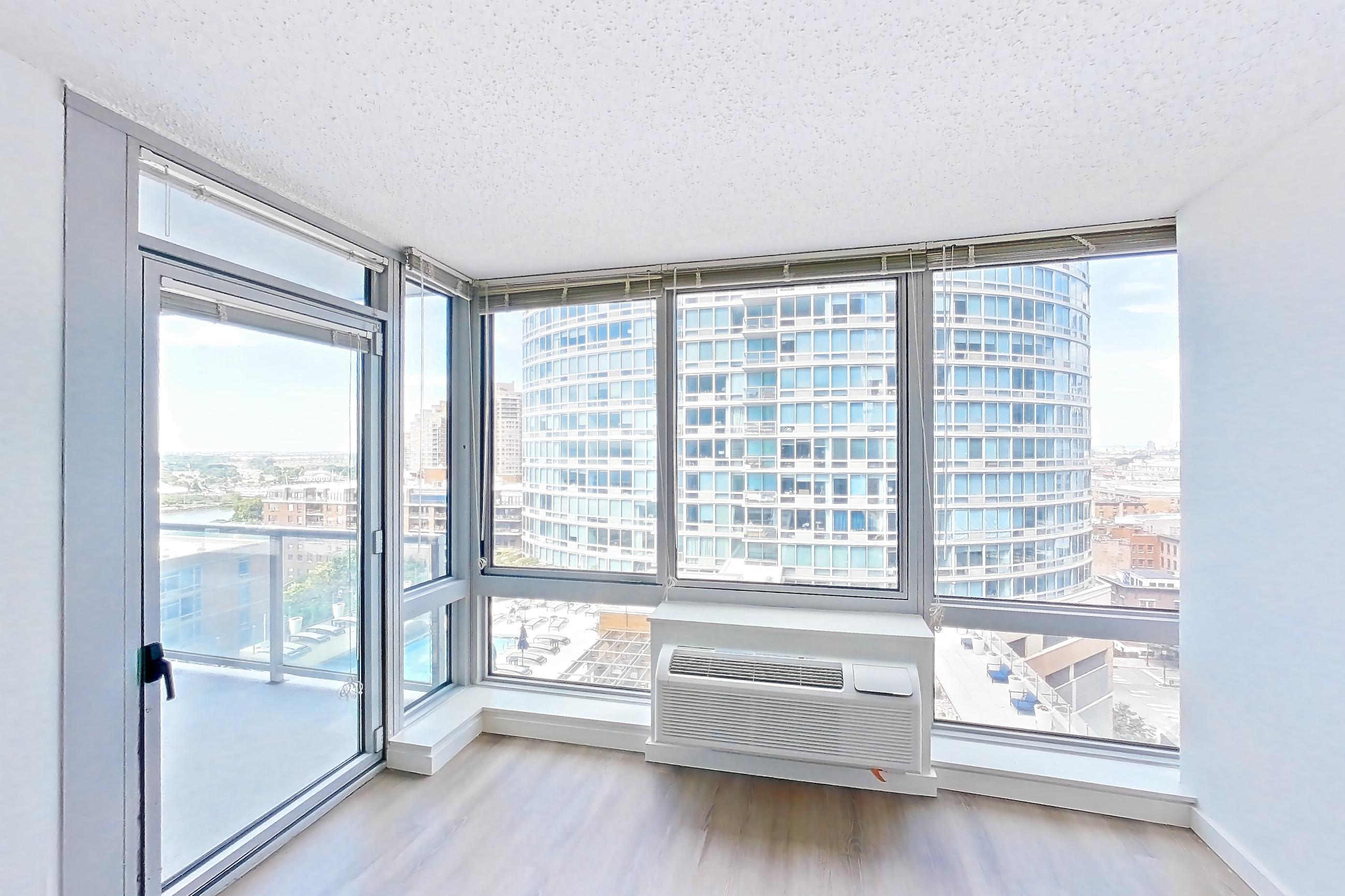 Living room with air conditioning and city view, Apartment LT-E1409 at Liberty Towers