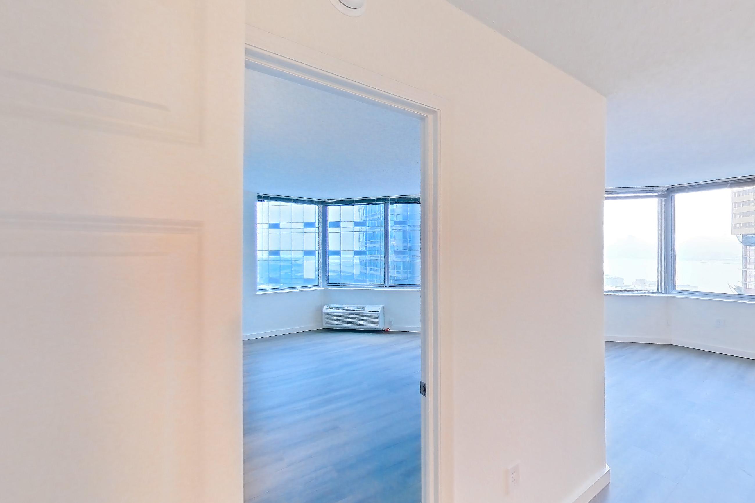Living room cloest with air conditioning and dark wood-finish flooring, Apartment LT-E2905 at Liberty Towers