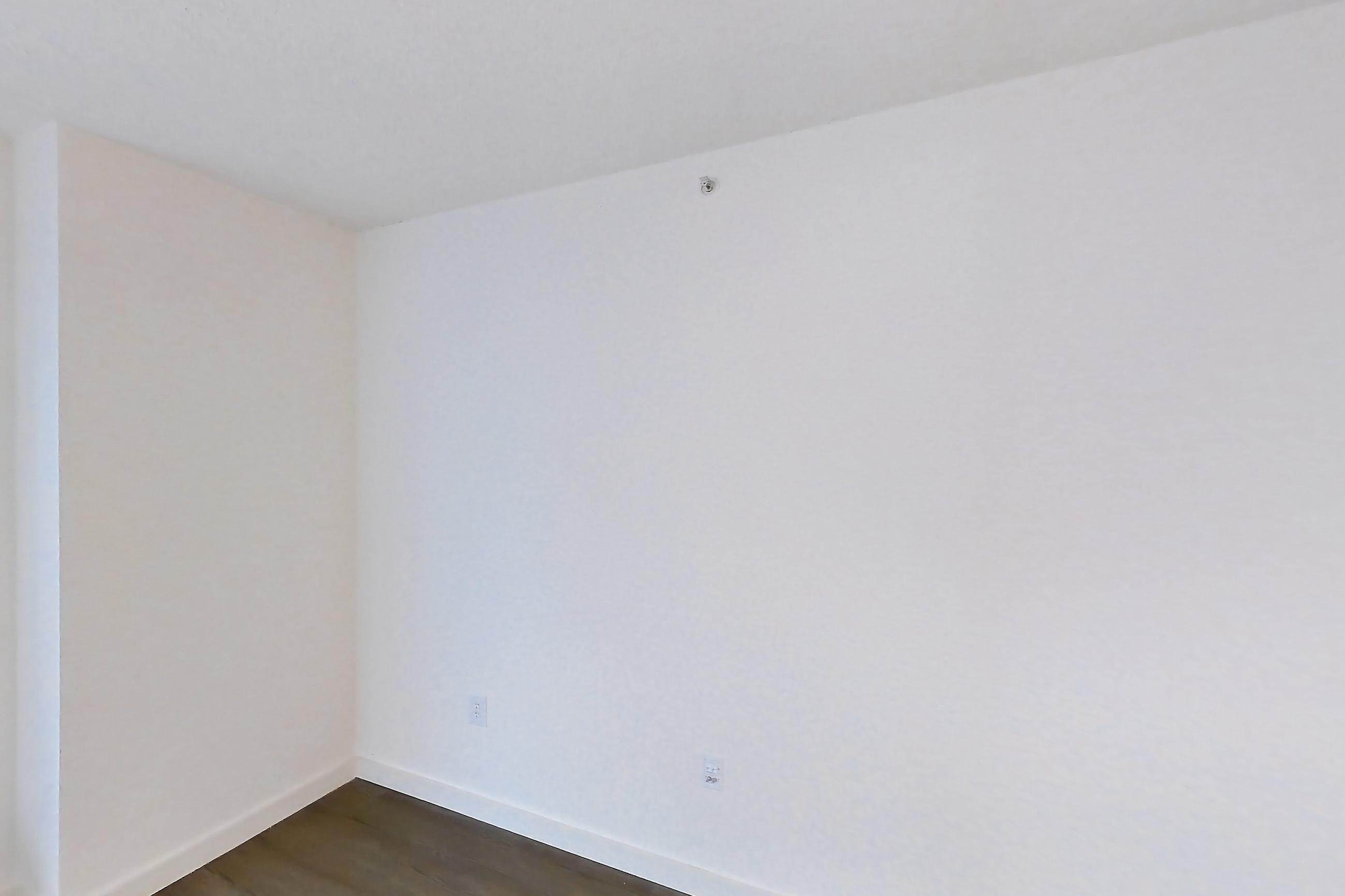 Living room with air conditioning and dark wood-finish flooring, Apartment LT-E2905 at Liberty Towers