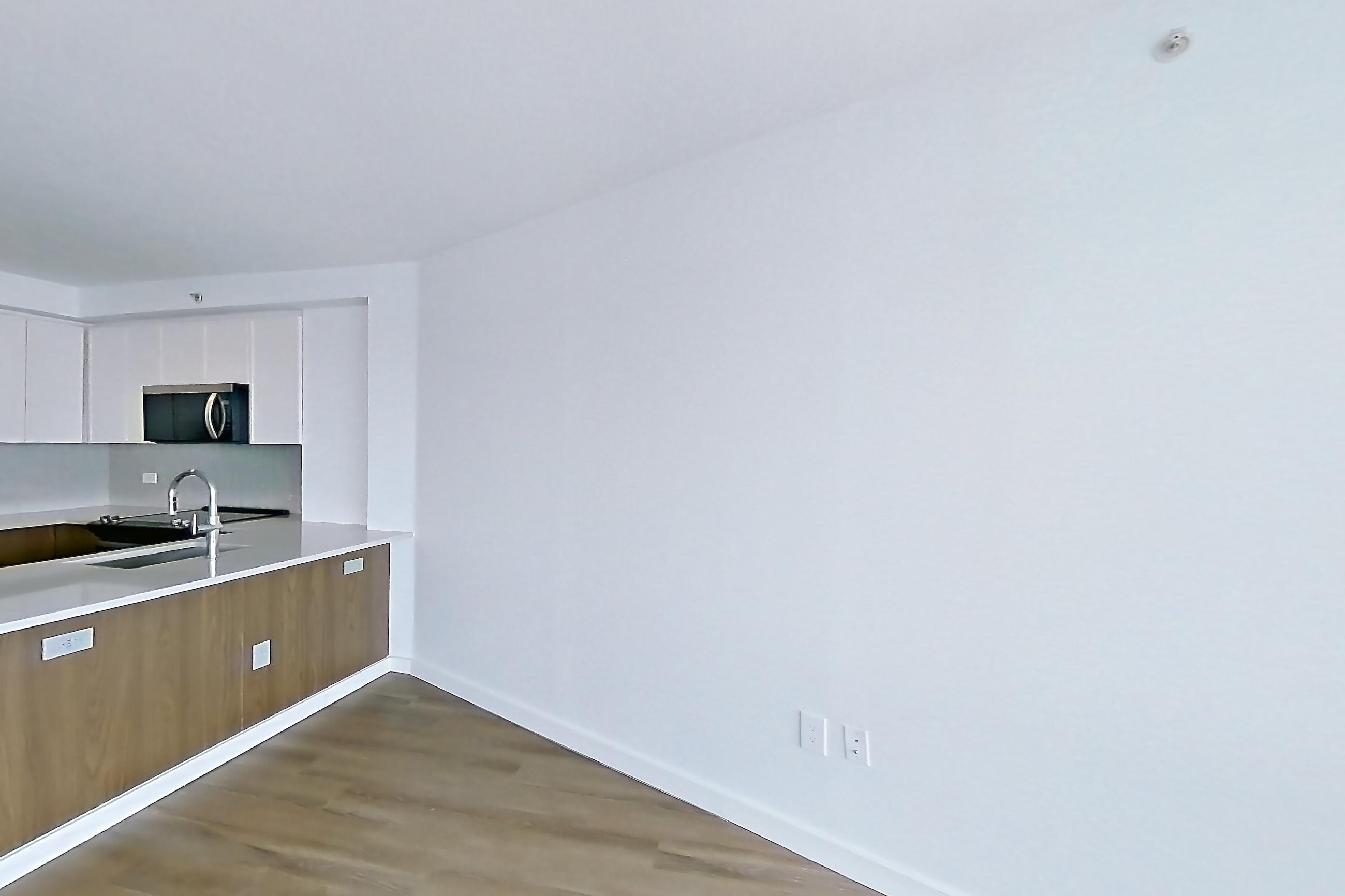 Living room with air conditioning and light wood-finish flooring, Apartment LT-W1811 at Liberty Towers