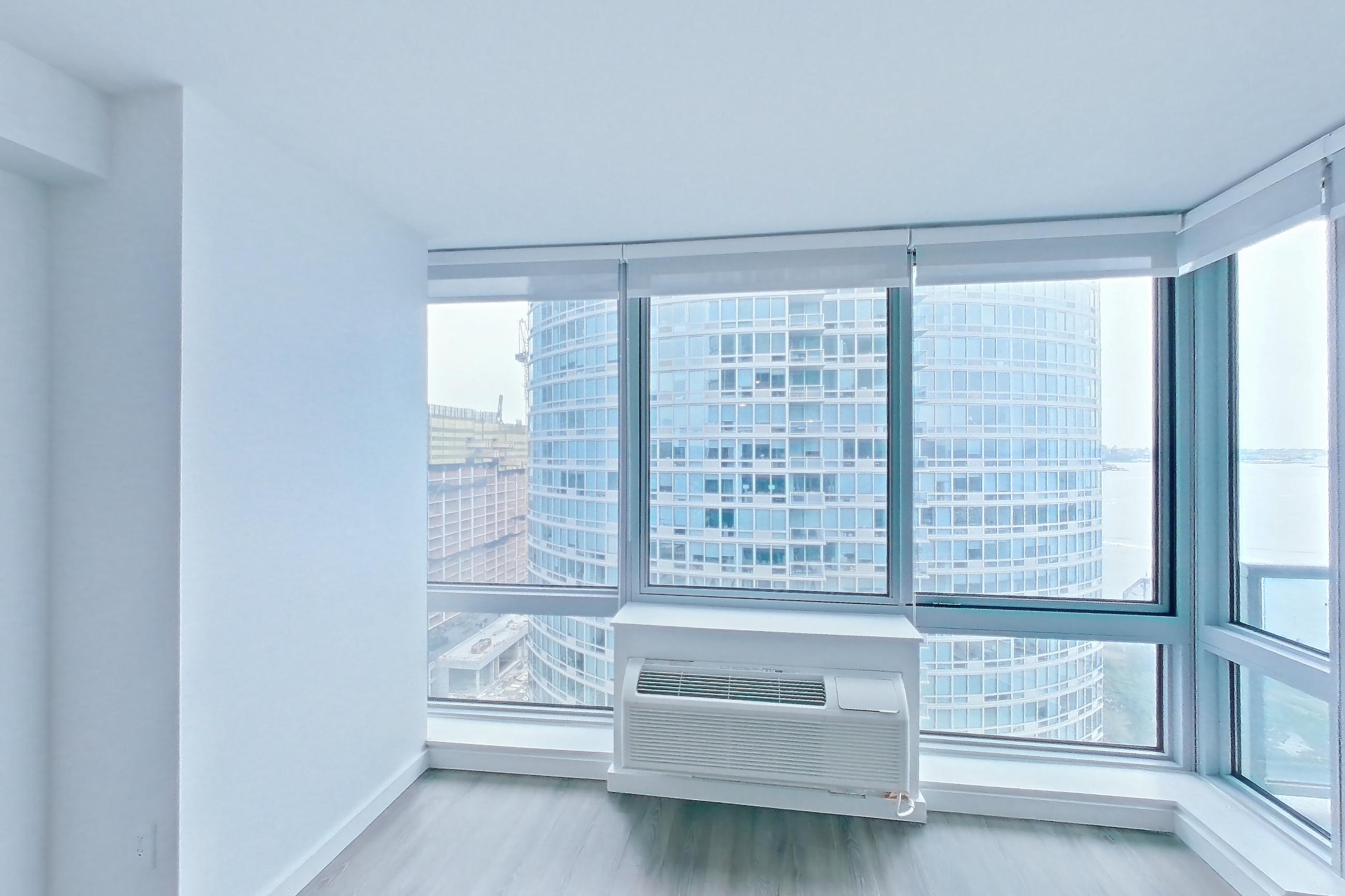 Living room with light wood-finish flooring, Apartment LT-W2409 at Liberty Towers