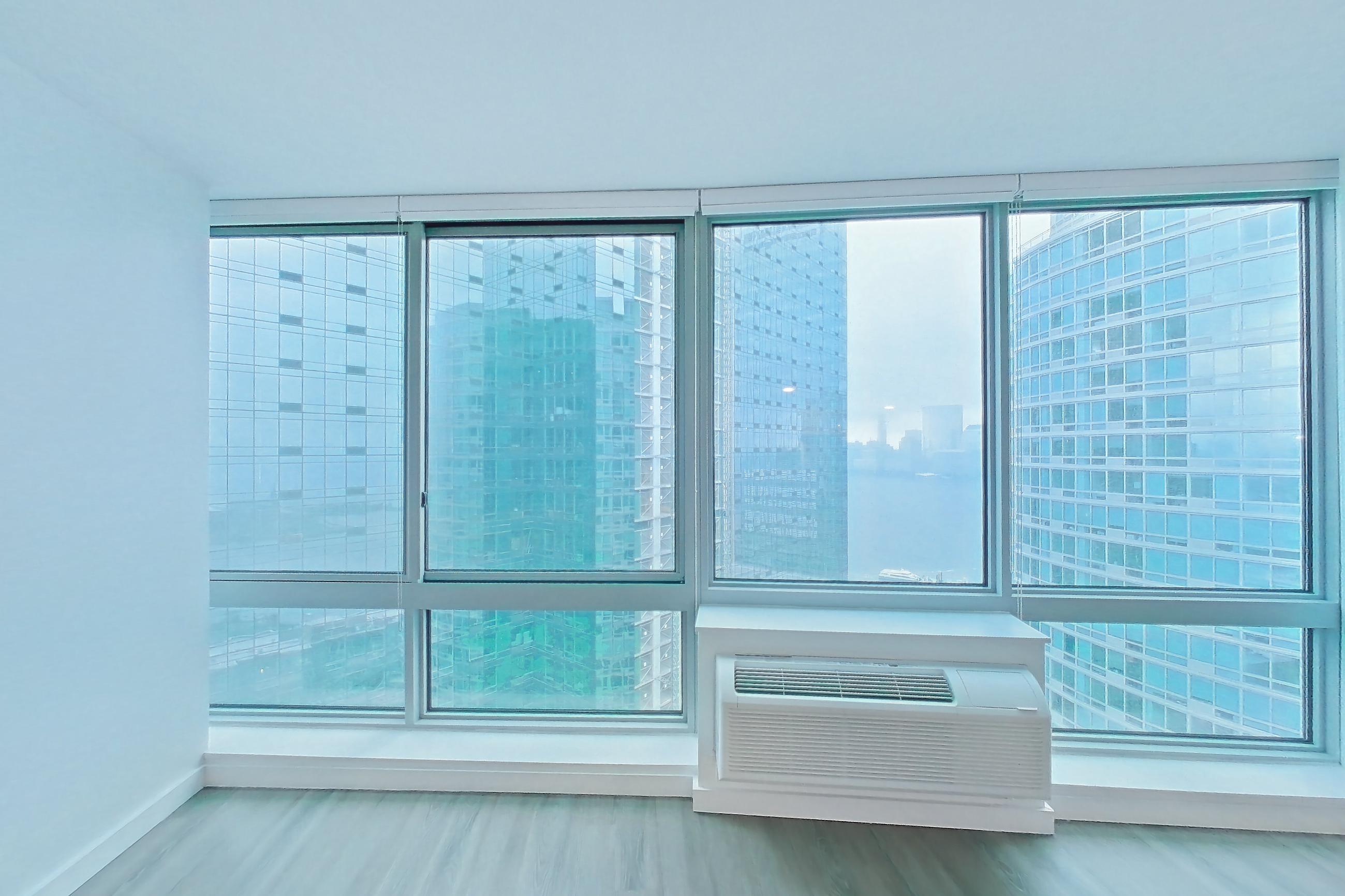 Living room with air conditioning and city view, Apartment LT-W2907 at Liberty Towers