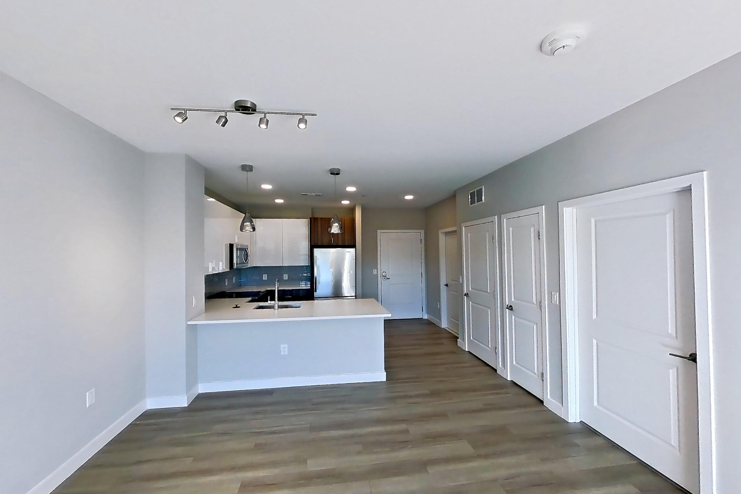 Living room in Apartment em-8415 at The Emery at Overlook Ridge, A3 floor plan