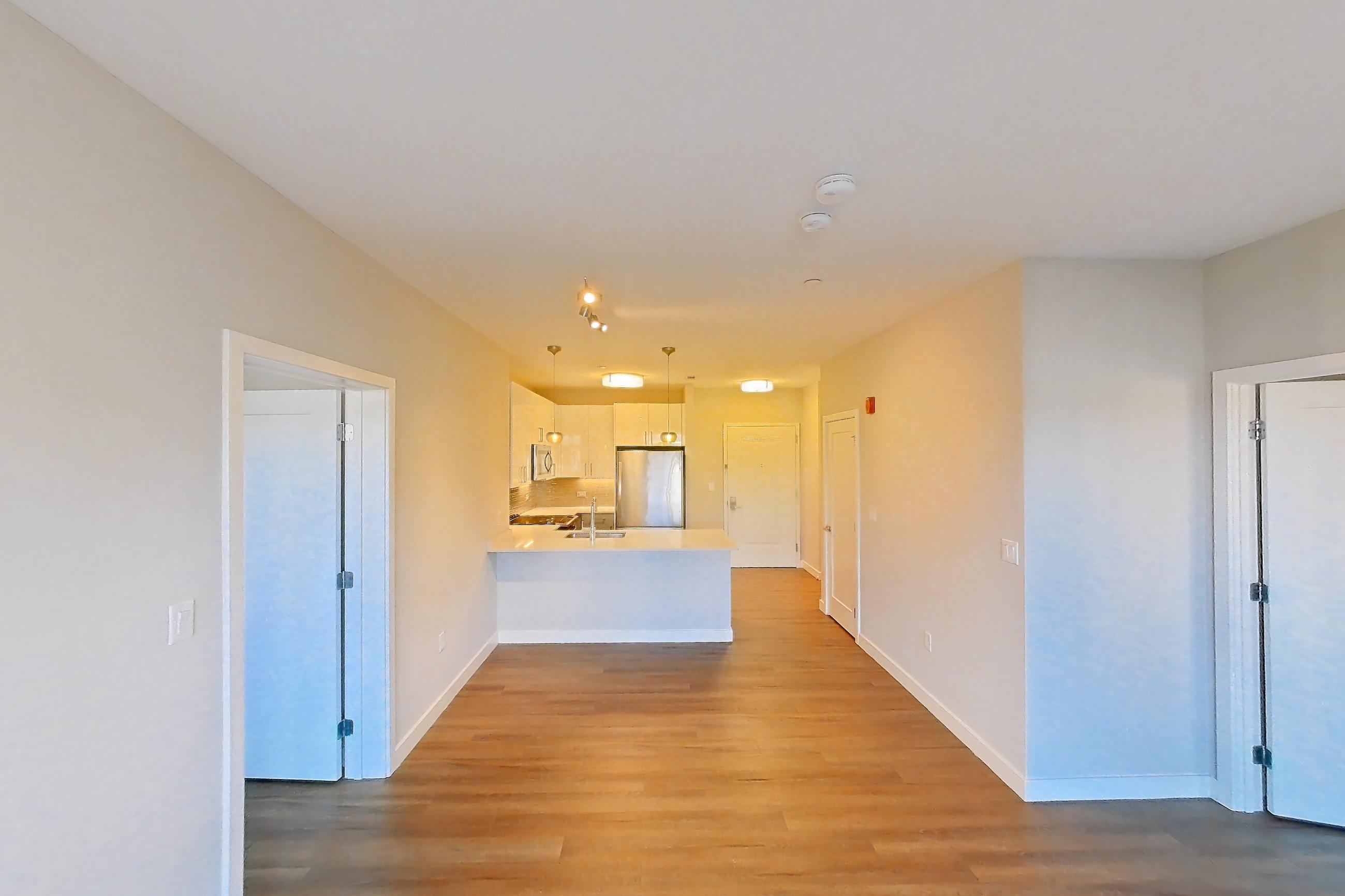 Living space with light wood-finish flooring, Apartment PE2-2416 at Beacon Collection