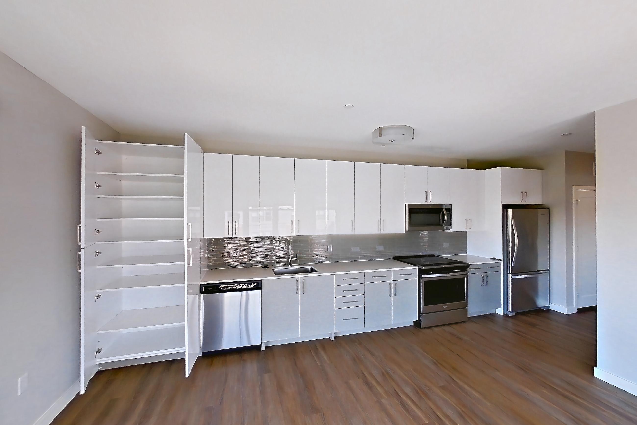 Kitchen in a 1 bd - 1 ba floor plan apartment, representative of Apartment PE2-2213 at Beacon Collection
