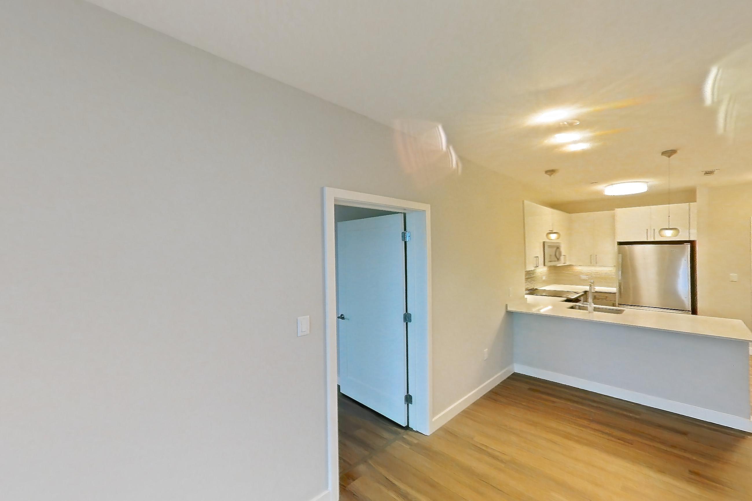 Living room with city view and light wood-finish flooring, Apartment PE2-3508 at Beacon Collection