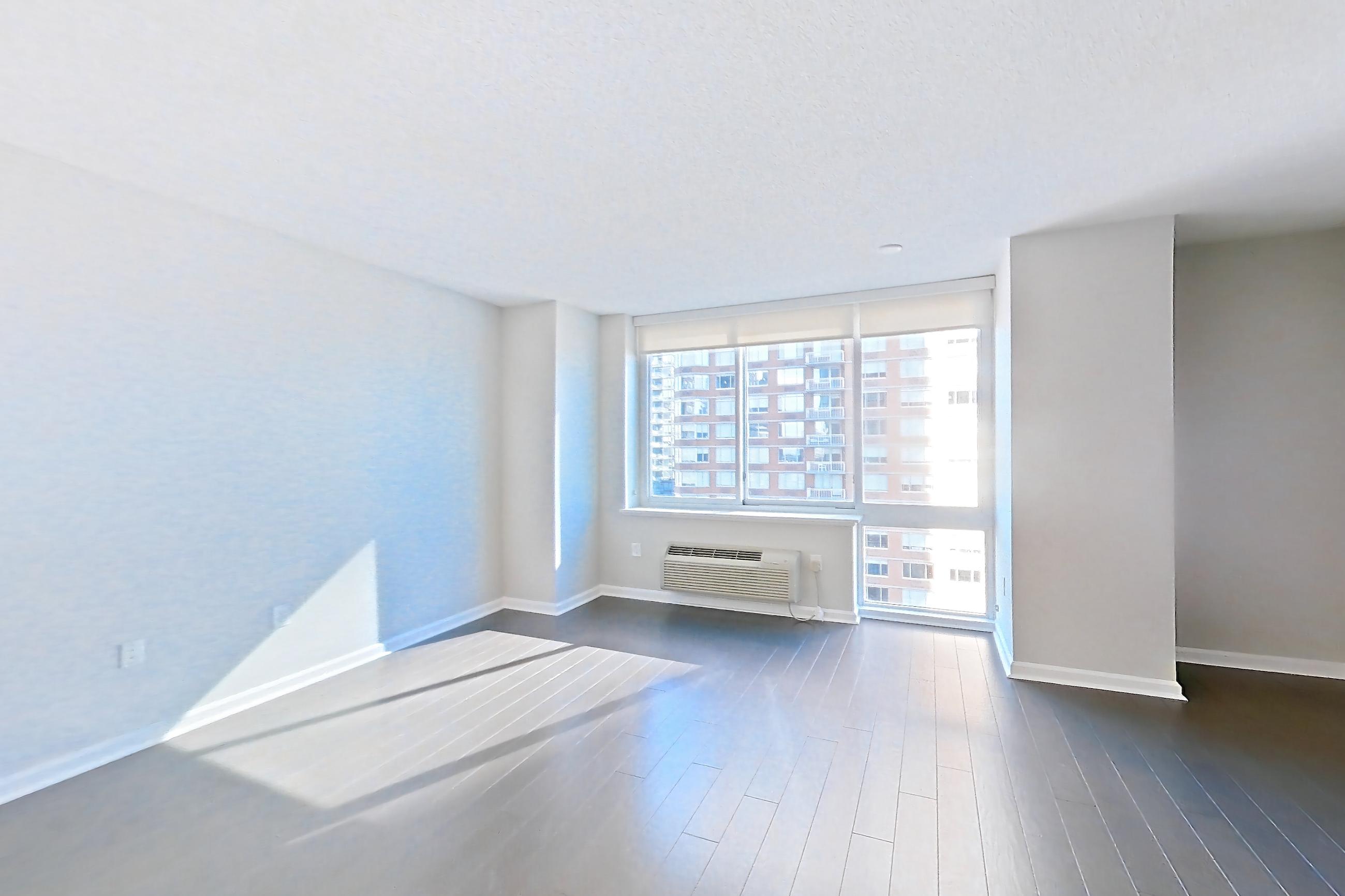 Living space entrance with air conditioning and dark wood-finish flooring, Apartment M2-1507 at BLVD Collection - 401 Washington Blvd