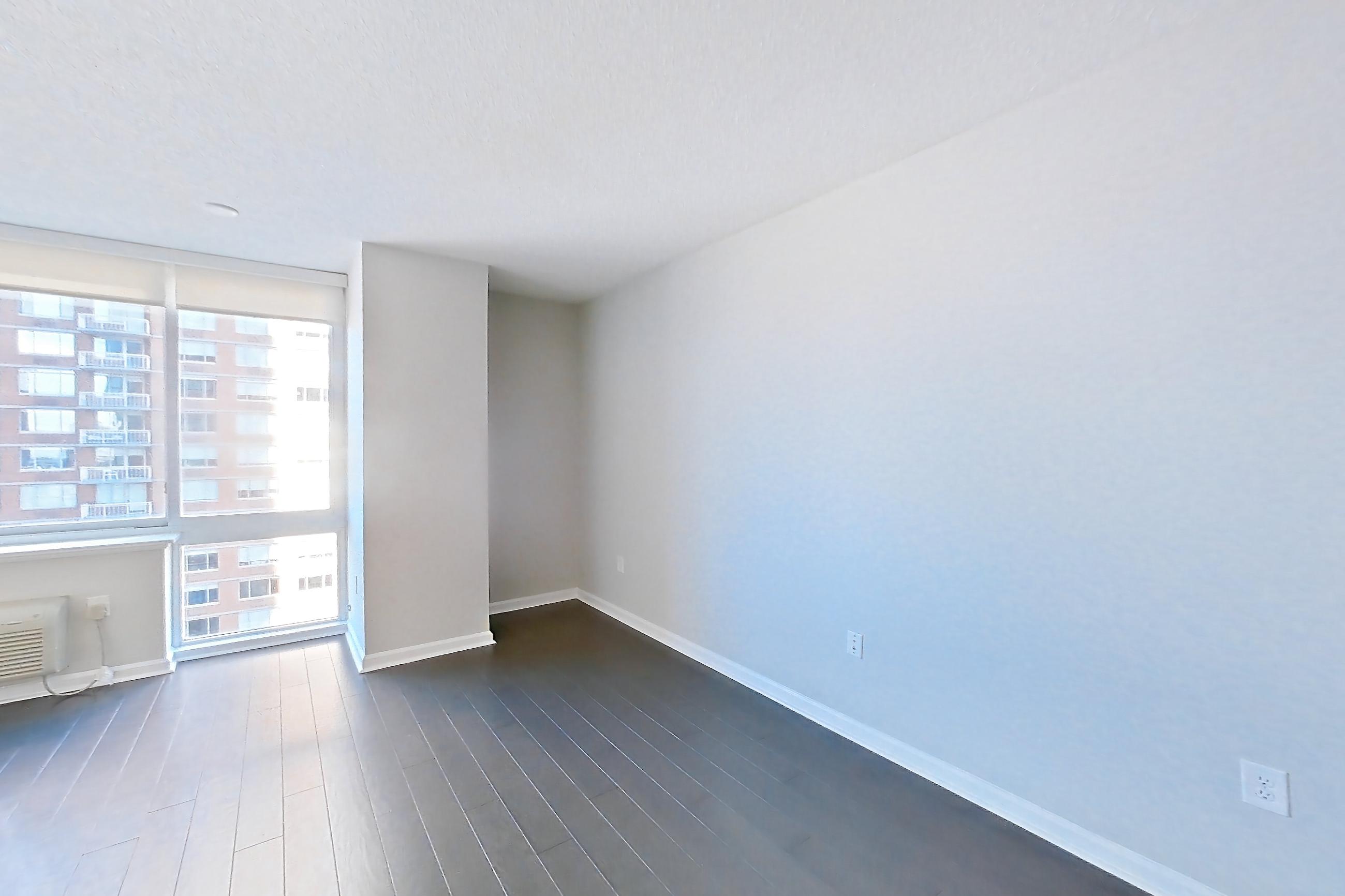 Living space entrance with air conditioning and dark wood-finish flooring, Apartment M2-1507 at BLVD Collection - 401 Washington Blvd