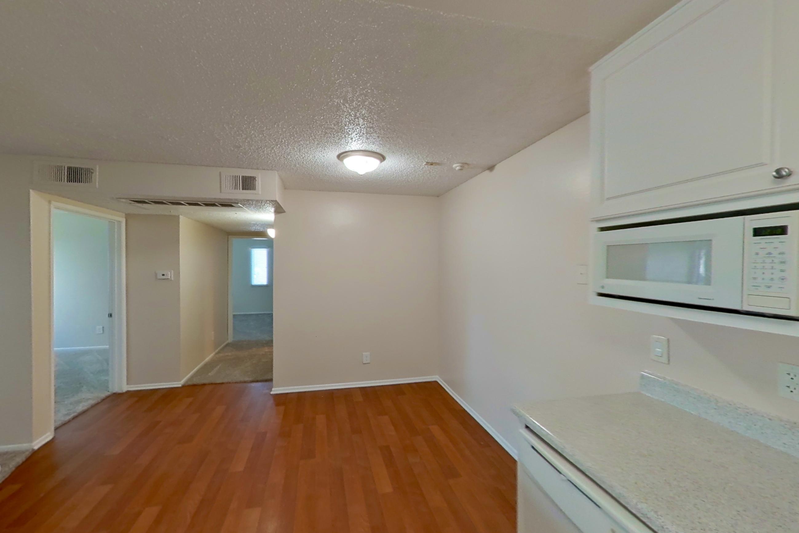 Kitchen with dishwasher, electric range, light countertops, light wood-finish flooring, oven/range, refrigerator, and white appliances, Apartment 16-16 at Avana Rancho Cucamonga