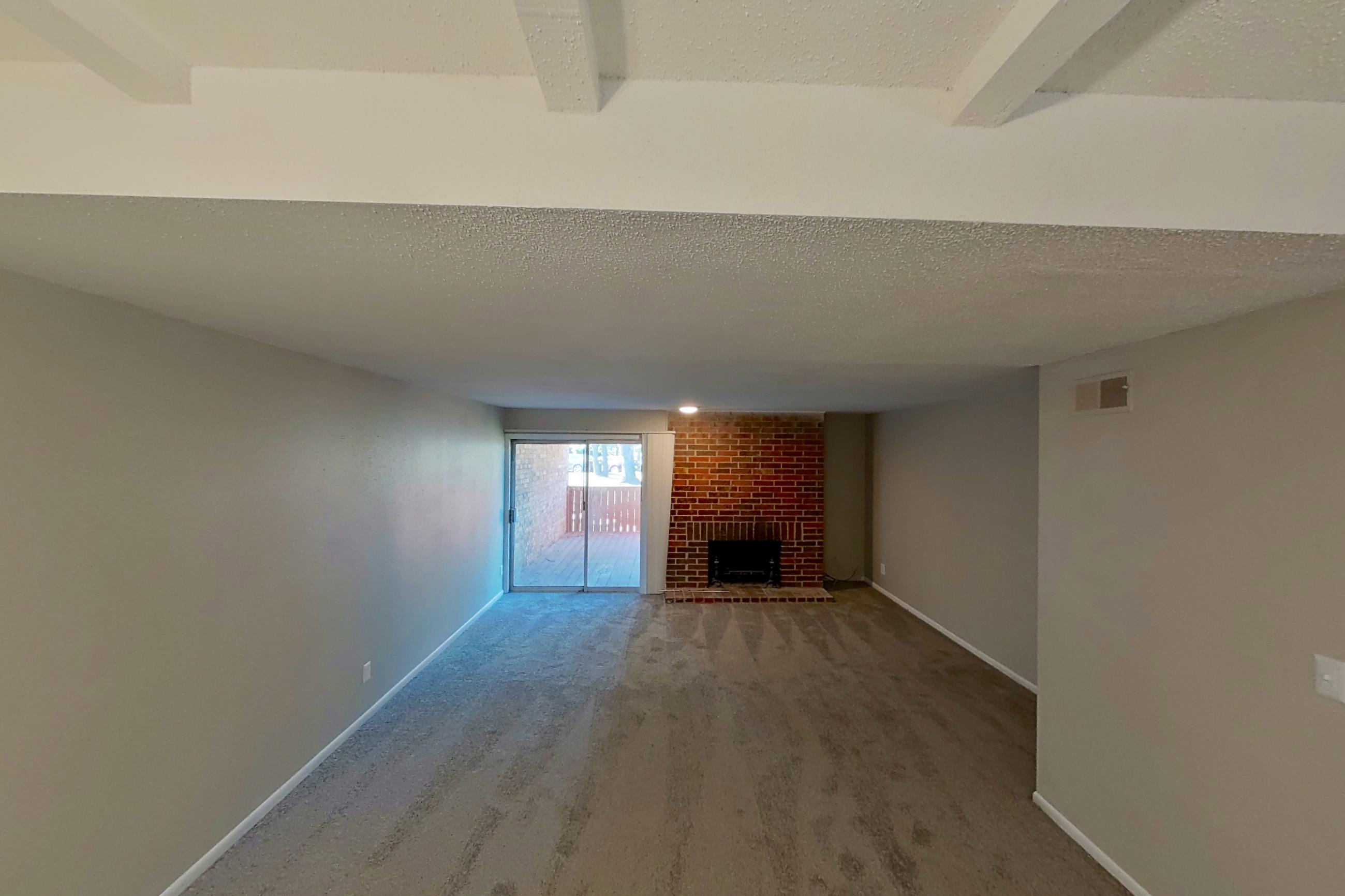 Living space with brick fireplace and fireplace, Apartment 1426A at The Life at Legacy Fountains