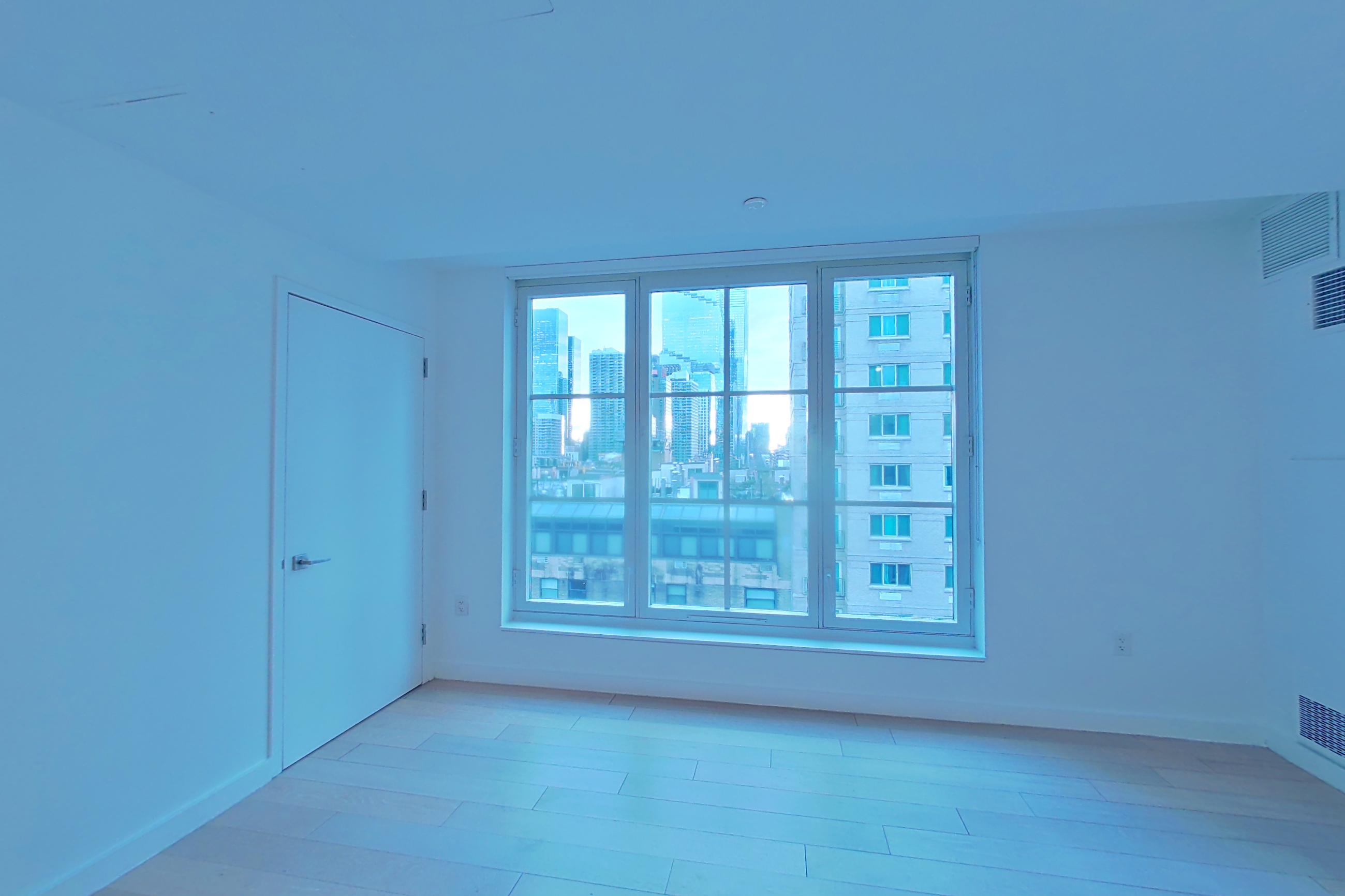Living space with city view and light wood-finish flooring, Apartment SOUTH PHA at 535W43