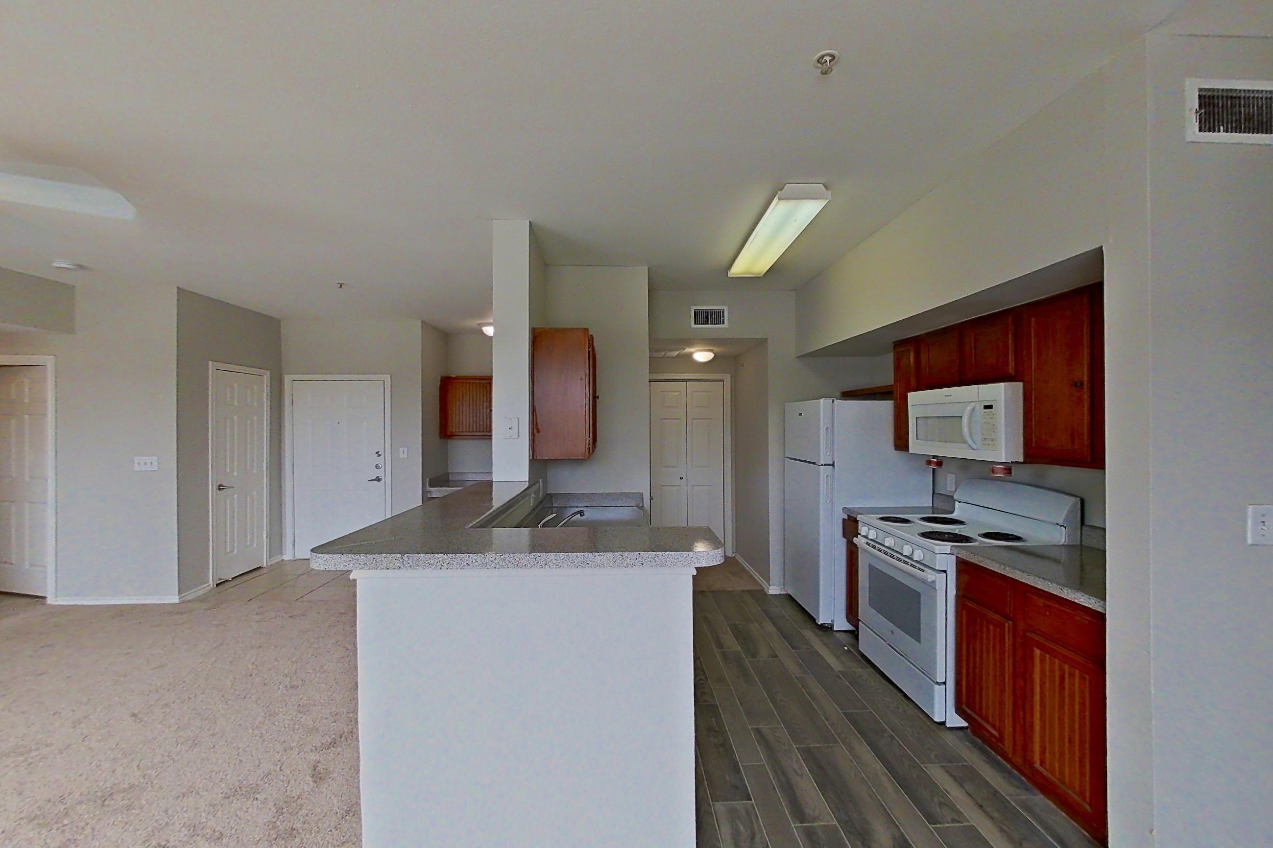 Dining room with electric range, light countertops, oven/range, refrigerator, and white appliances, Apartment 1205 at The Life at Brighton Estates