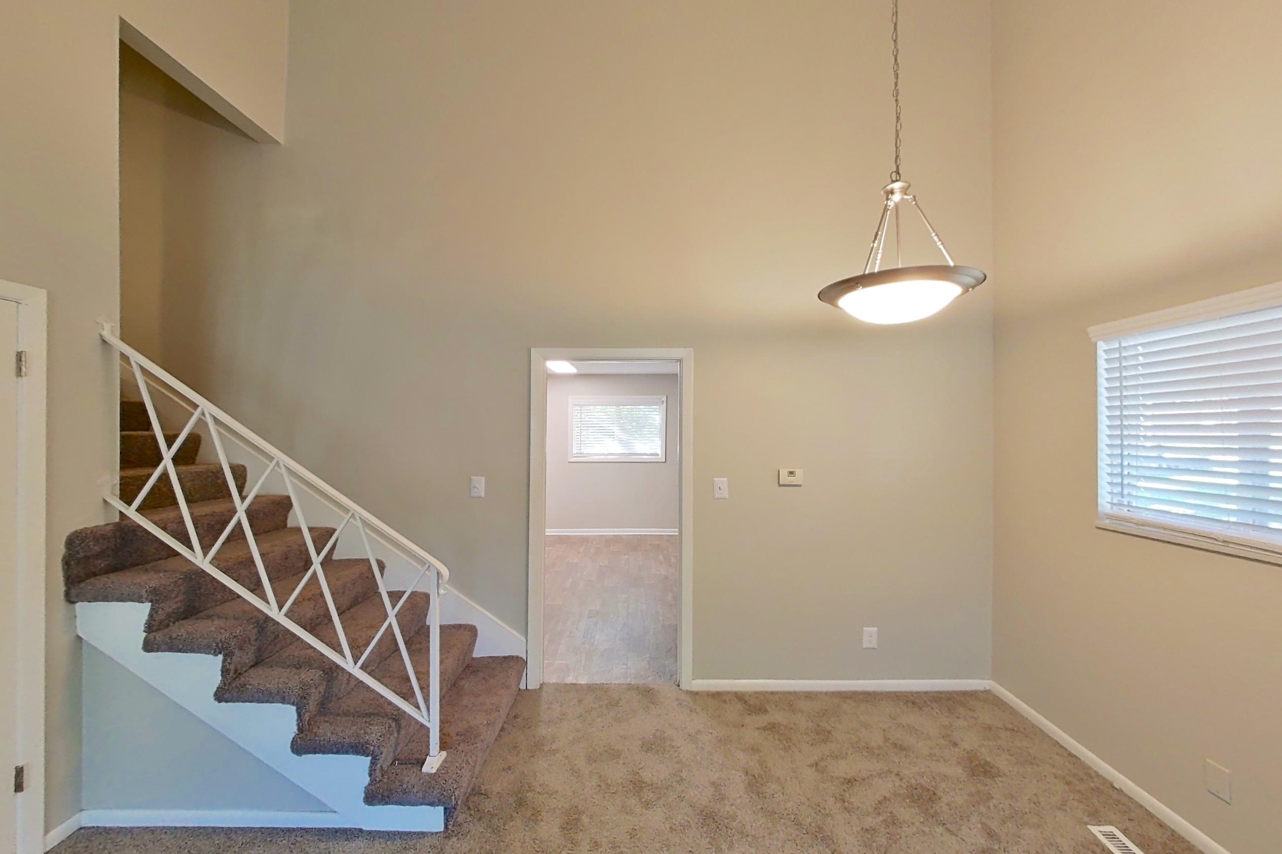 Living room with brick fireplace and fireplace, Apartment 1707 at The Life at Legacy Fountains