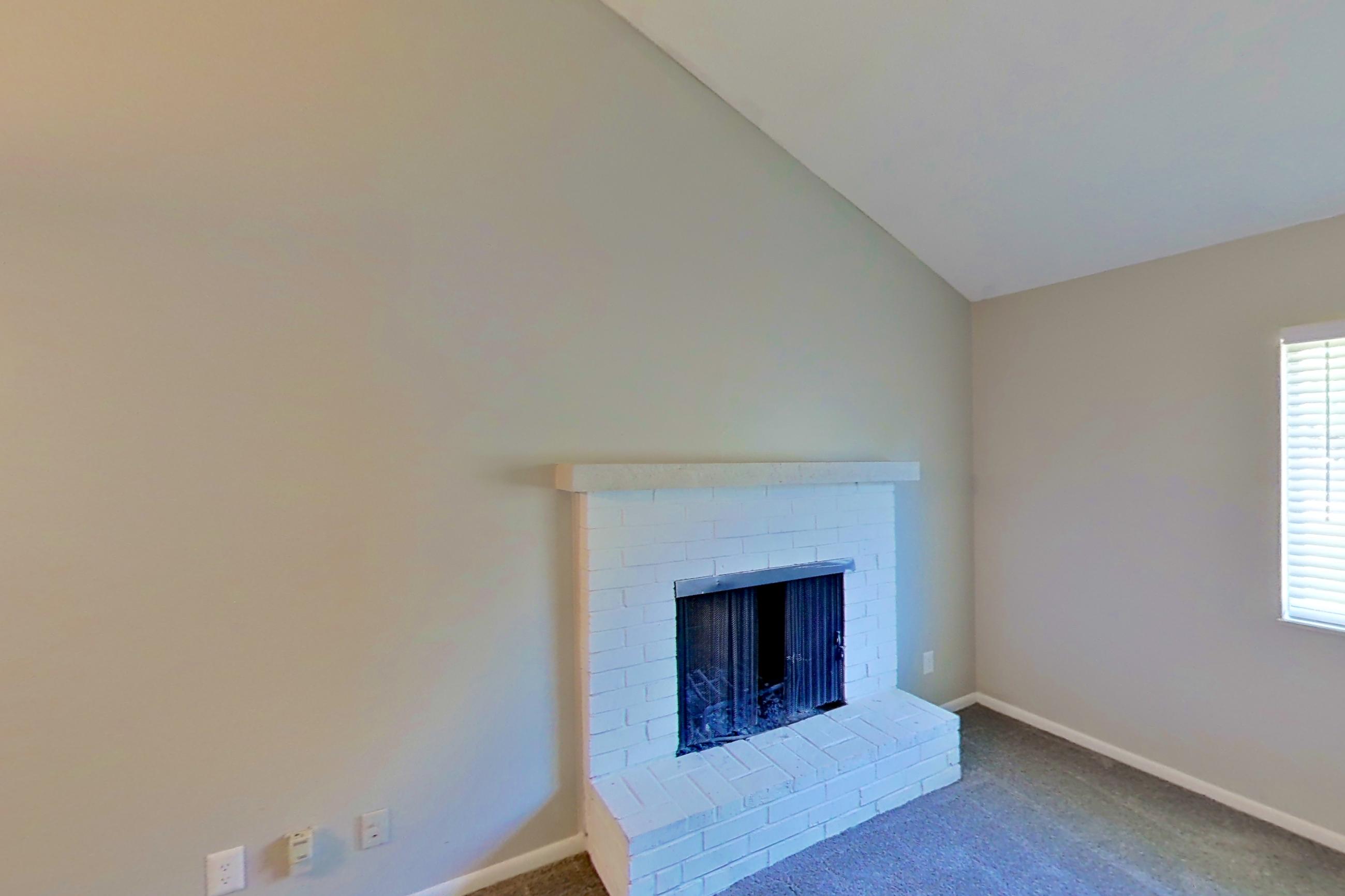 Living room with brick fireplace and fireplace, Apartment 1707 at The Life at Legacy Fountains