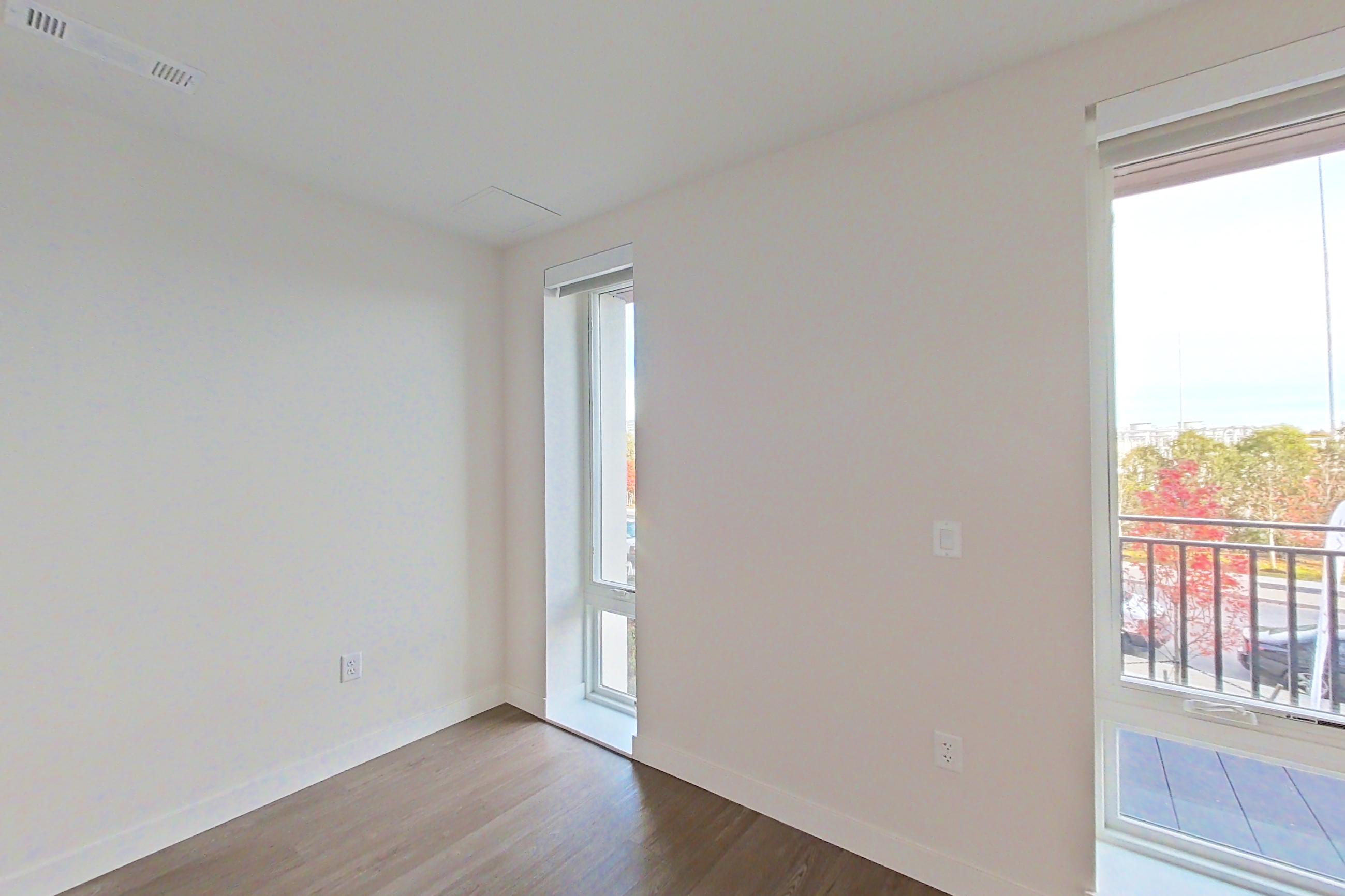 Living space with dark wood-finish flooring, Apartment B229 at The Laurent