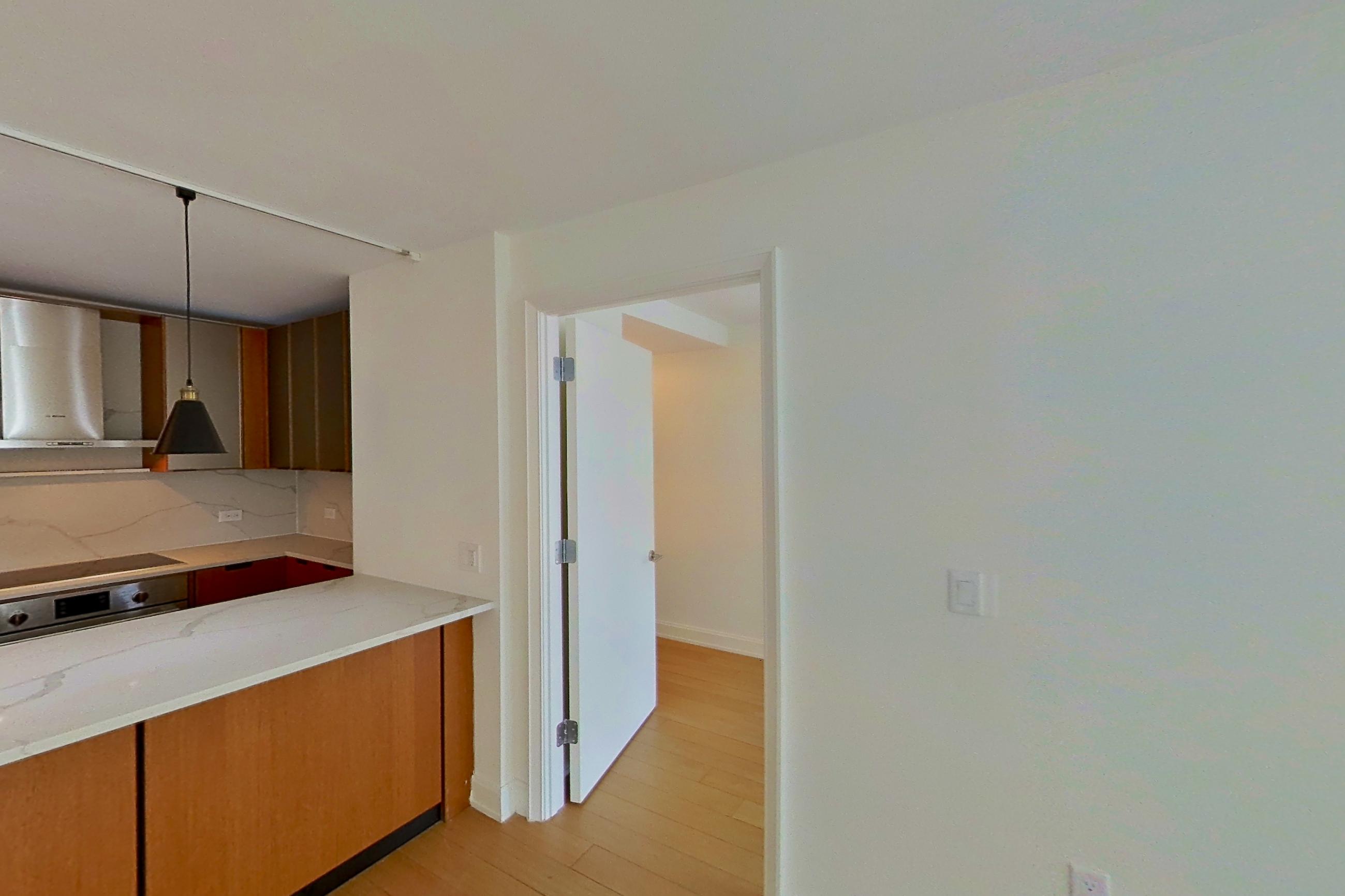Living room with light wood-finish flooring and wood-finish flooring, Apartment 1603 at Oriana