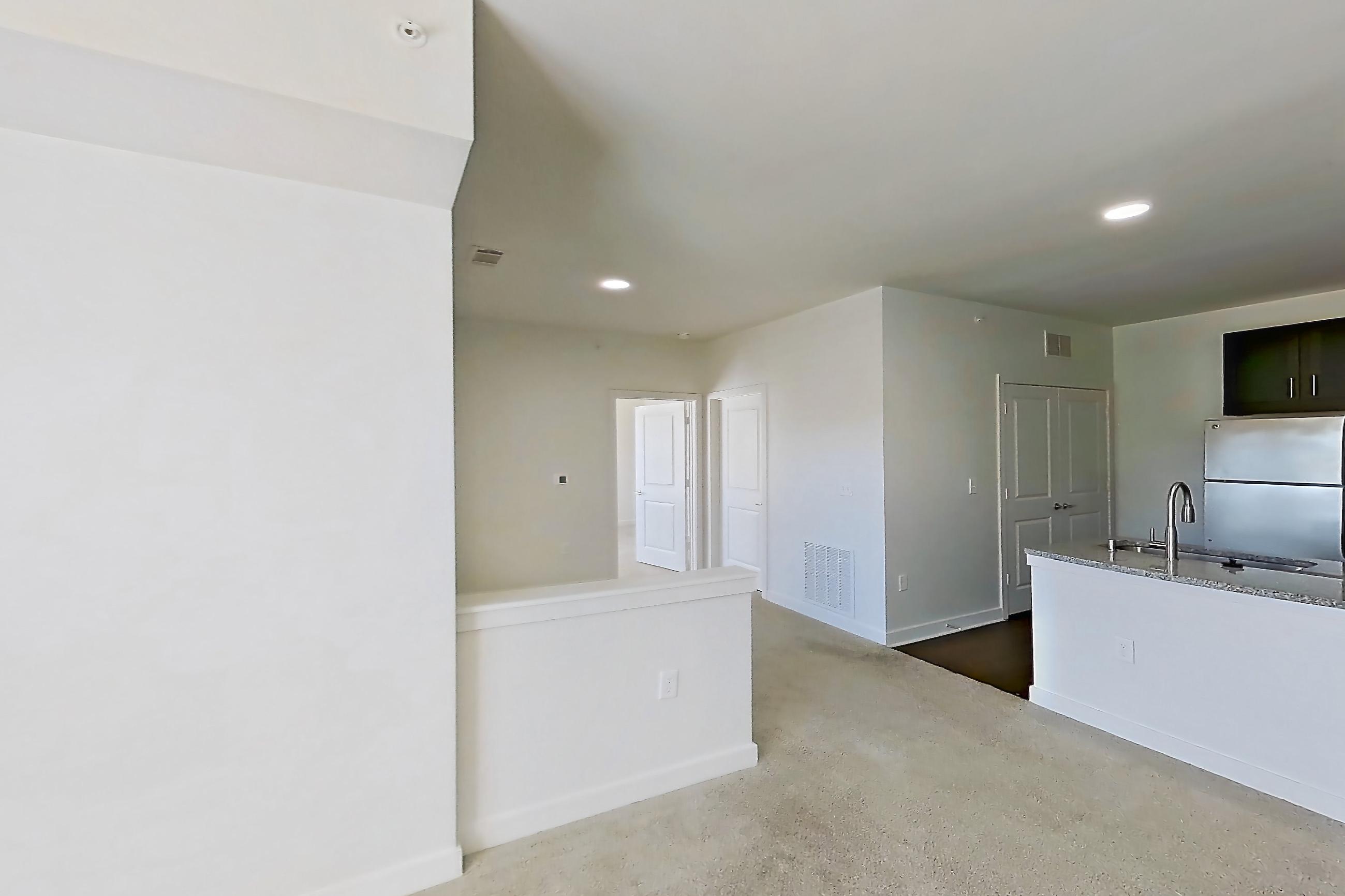 Living room with light carpet, Apartment 101 at Realm at Patterson Place