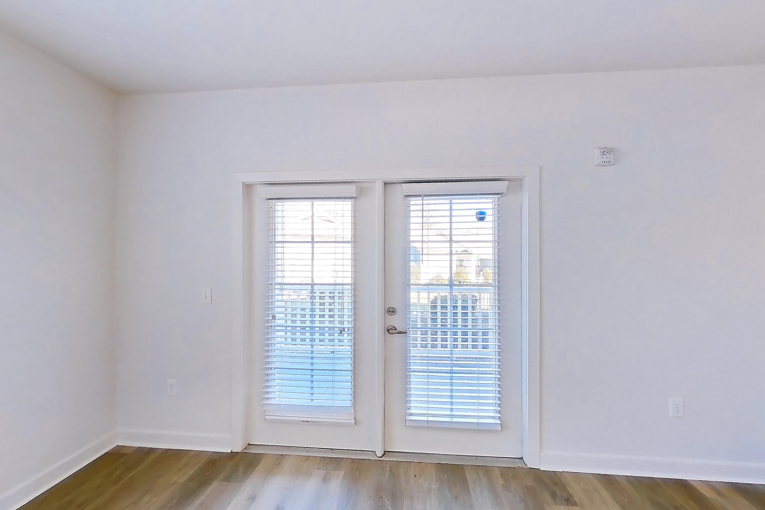 Living room with light wood-finish flooring, Apartment 304 at Realm at Patterson Place
