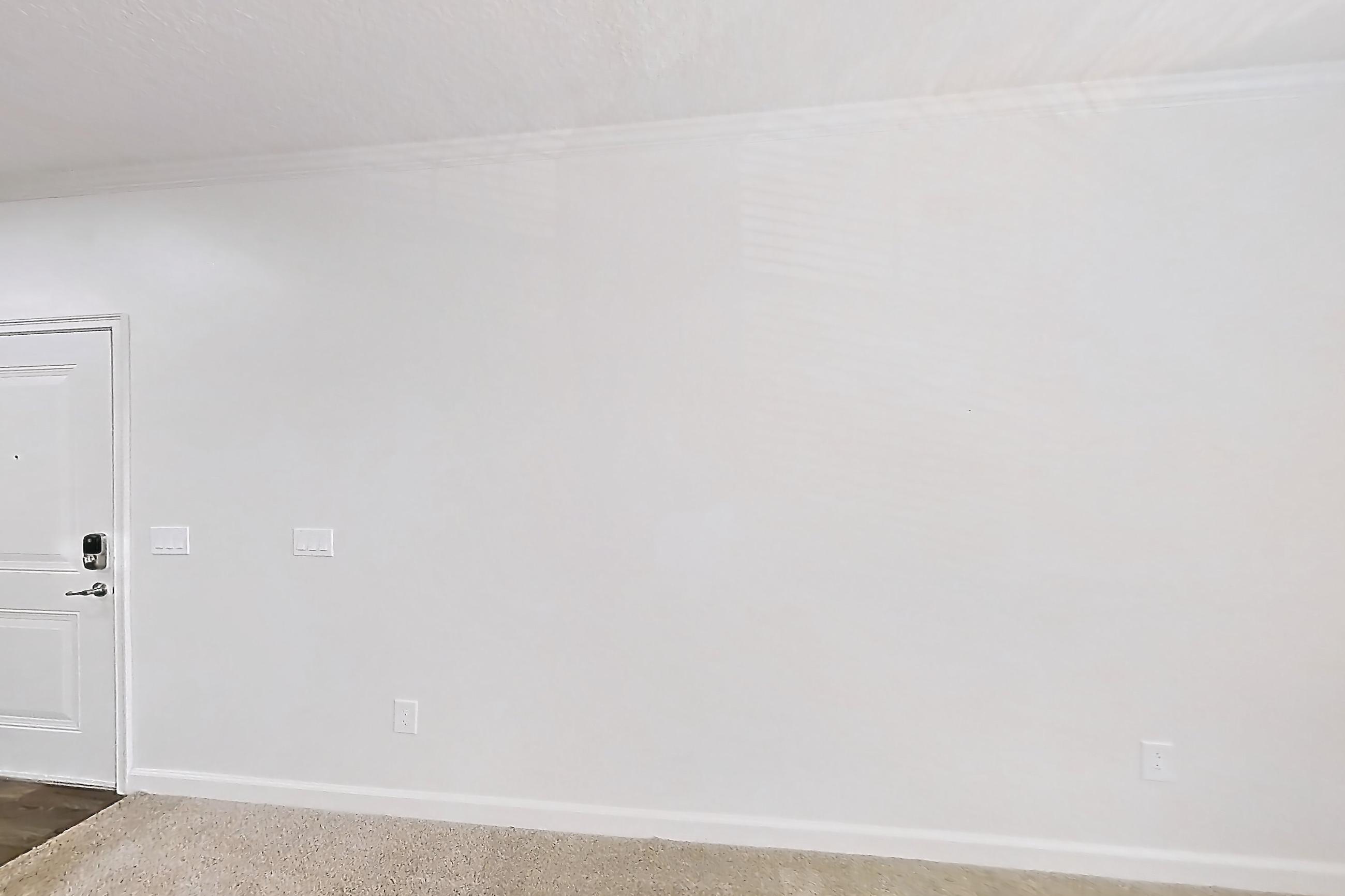 Living room with dark carpet, dishwasher, electric range, light stone countertops, oven/range, refrigerator, and stainless steel appliances, Apartment 6028 at Lantower Grande Pines