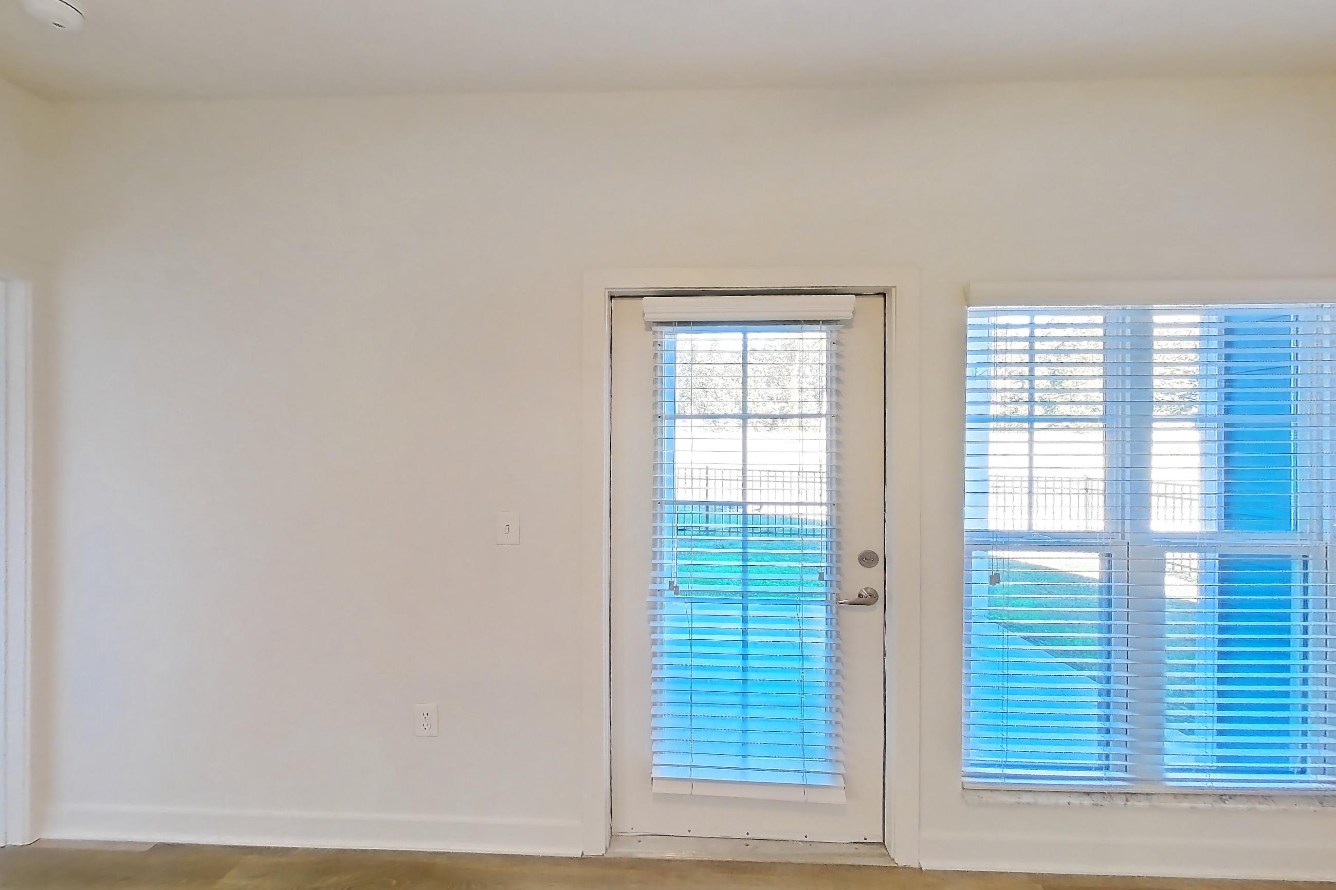 Living room with light wood-finish flooring, Apartment 008 at Realm at Patterson Place