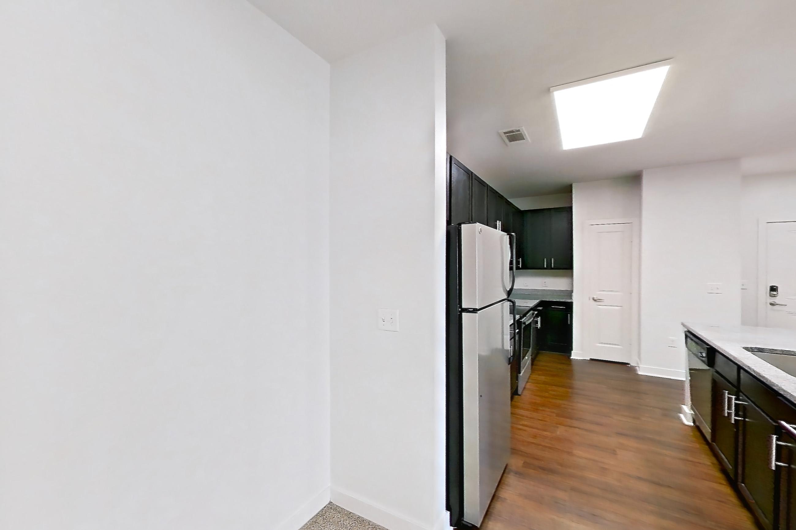 Dining room with dark carpet, kitchen island, light stone countertops, refrigerator, and white appliances, Apartment 208 at Realm at Patterson Place
