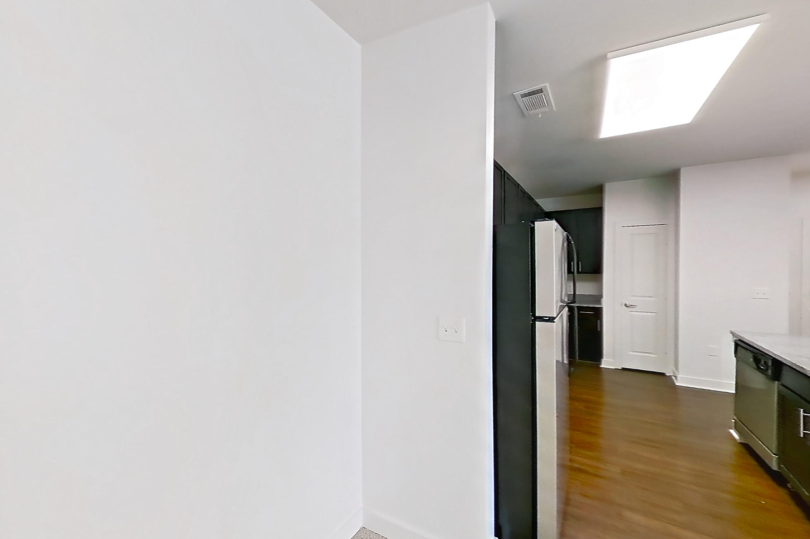Dining room with dark carpet, dishwasher, kitchen island, light stone countertops, refrigerator, and stainless steel appliances, Apartment 301 at Realm at Patterson Place