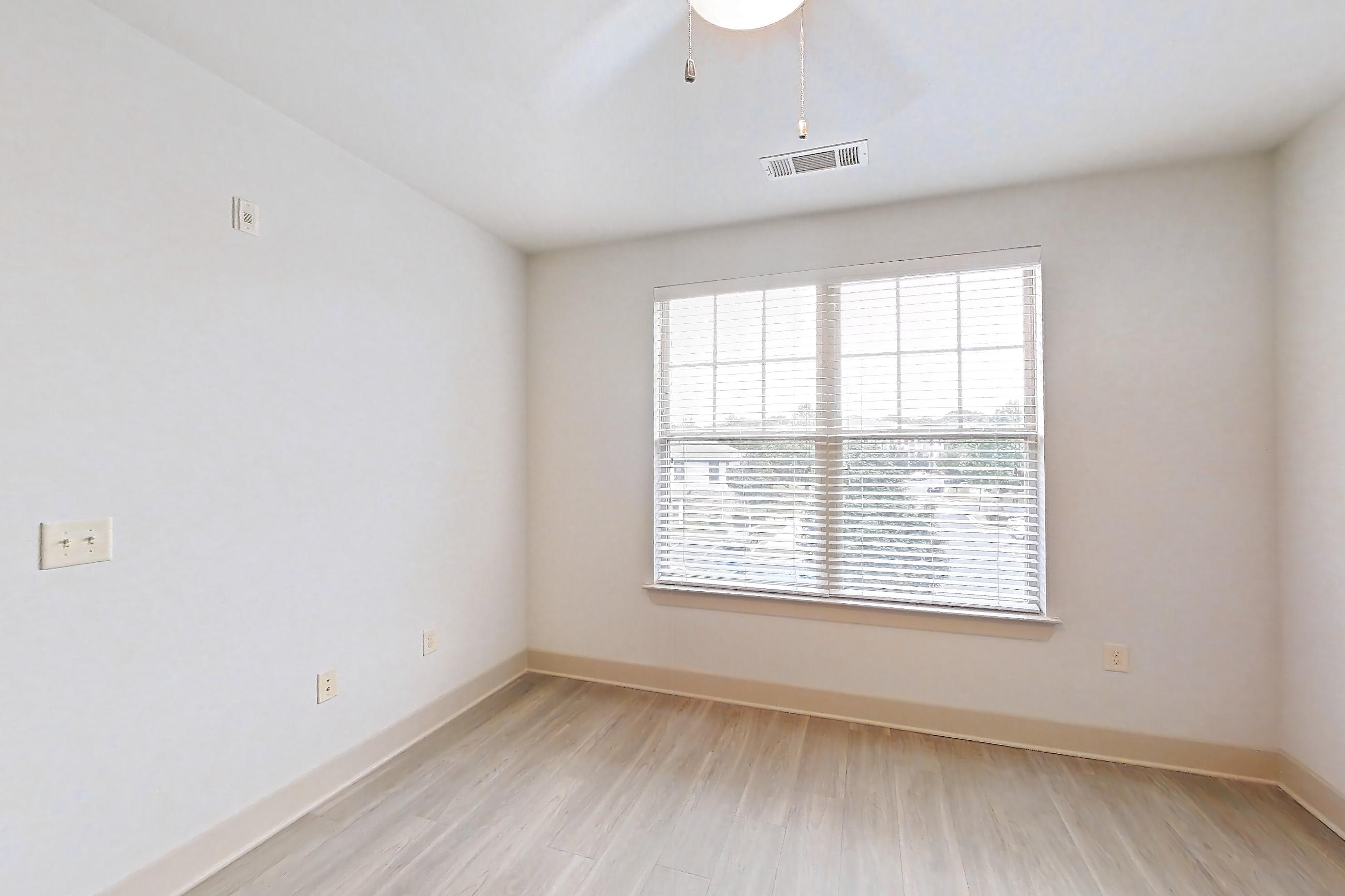 Living space with light wood-finish flooring, Apartment 10315 at Lantower Waverly