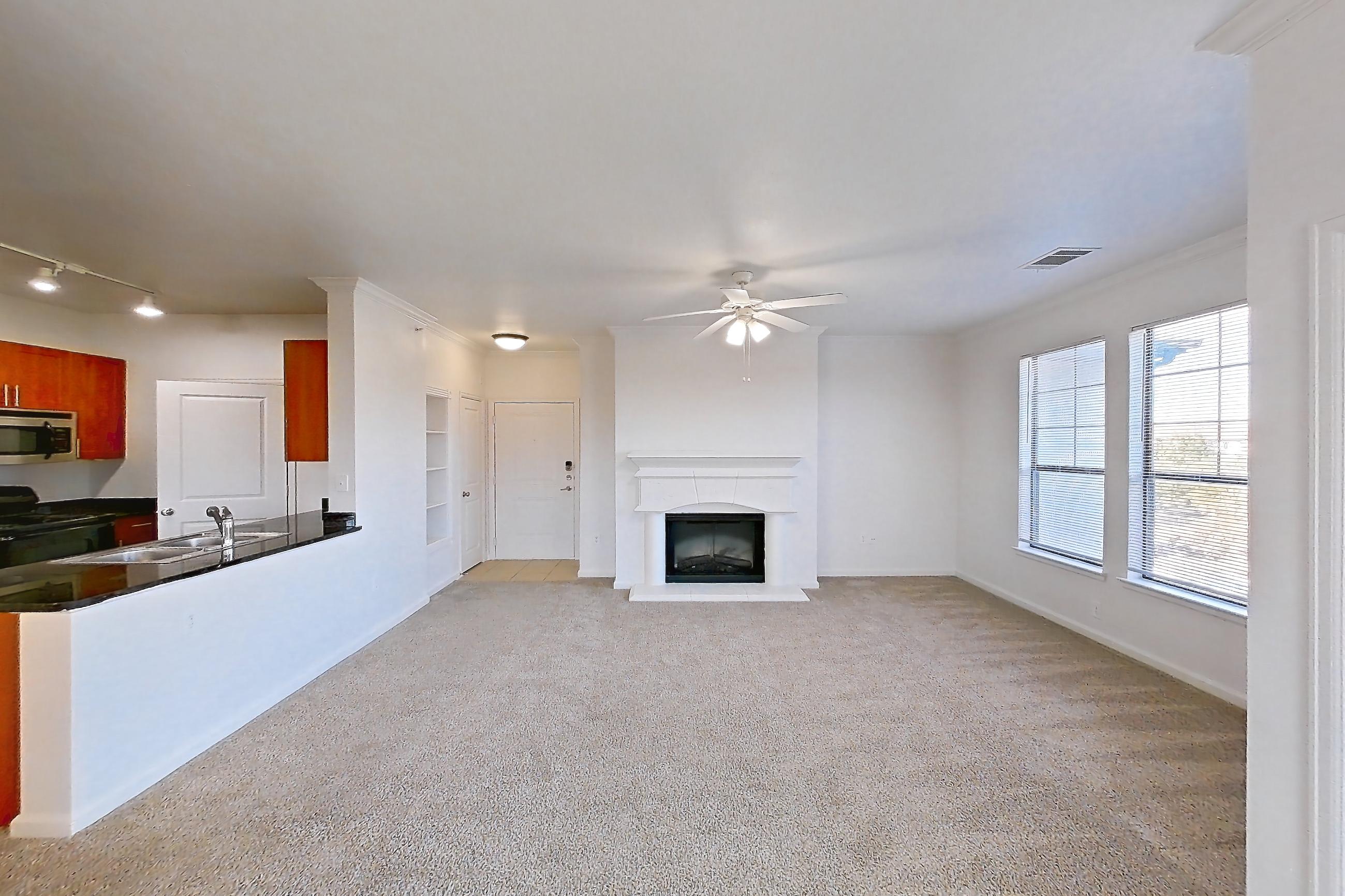 Dining room with fireplace and light carpet, Apartment 1031 at The Cortona
