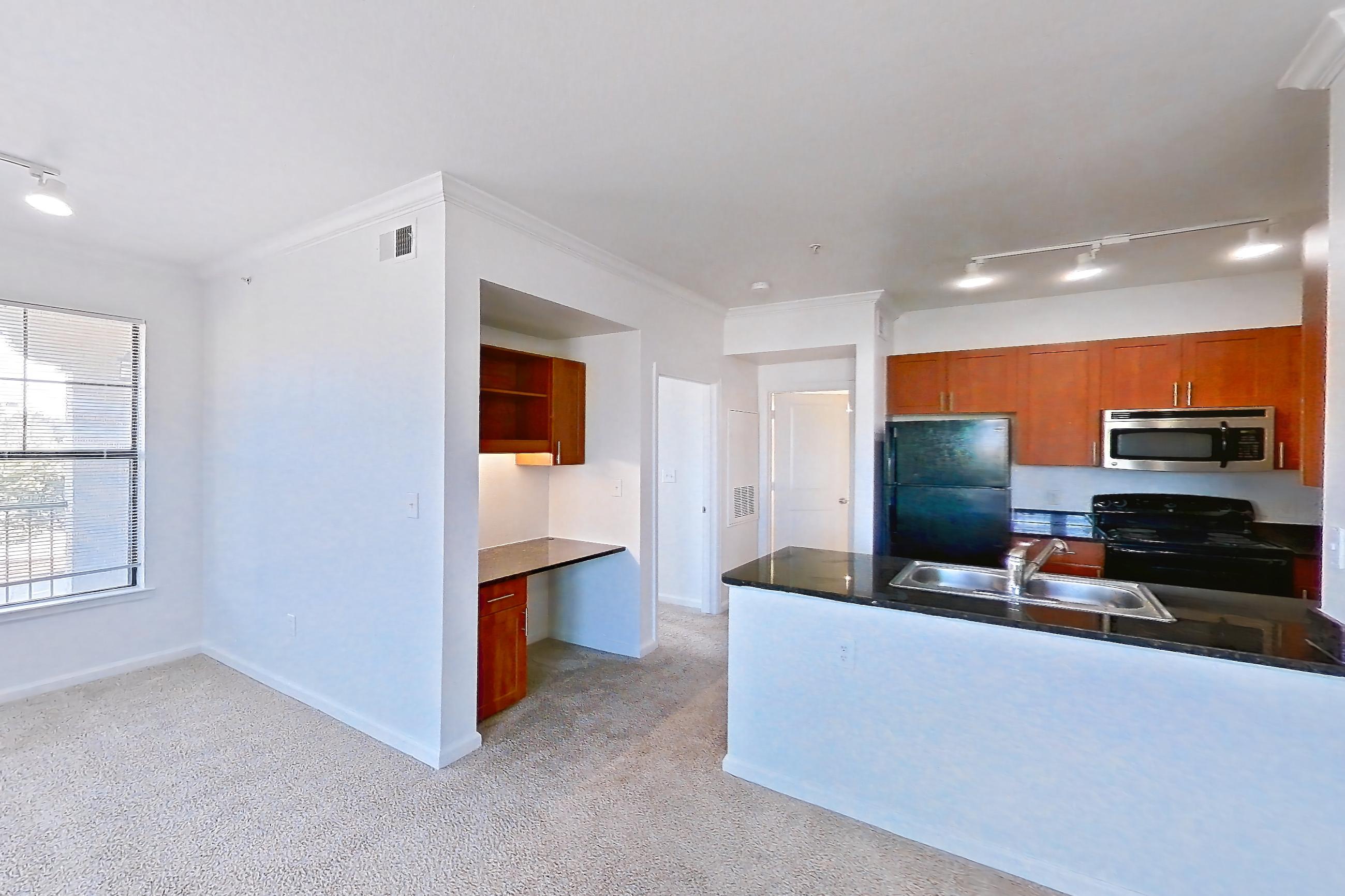 Living room with black appliances, dark countertops, electric range, light carpet, oven/range, and refrigerator, Apartment 1031 at The Cortona