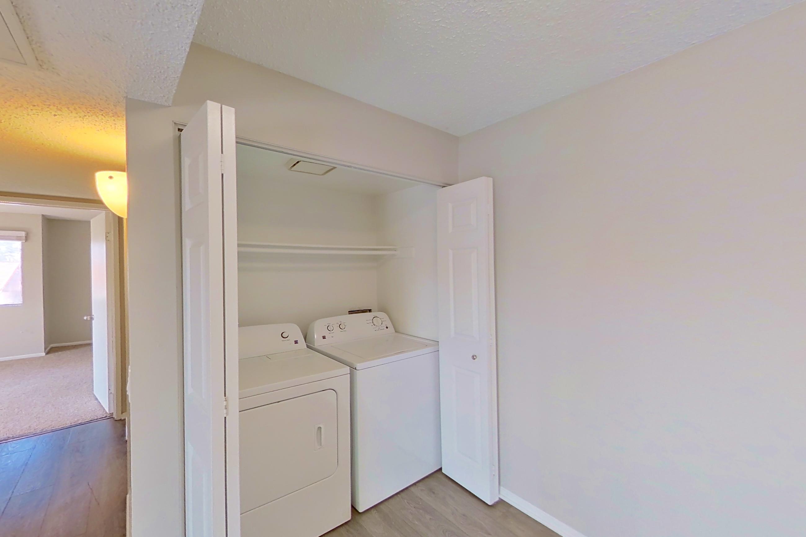 Dining area with in-unit laundry and light wood-finish flooring, Apartment 16-09 at Avana Rancho Cucamonga