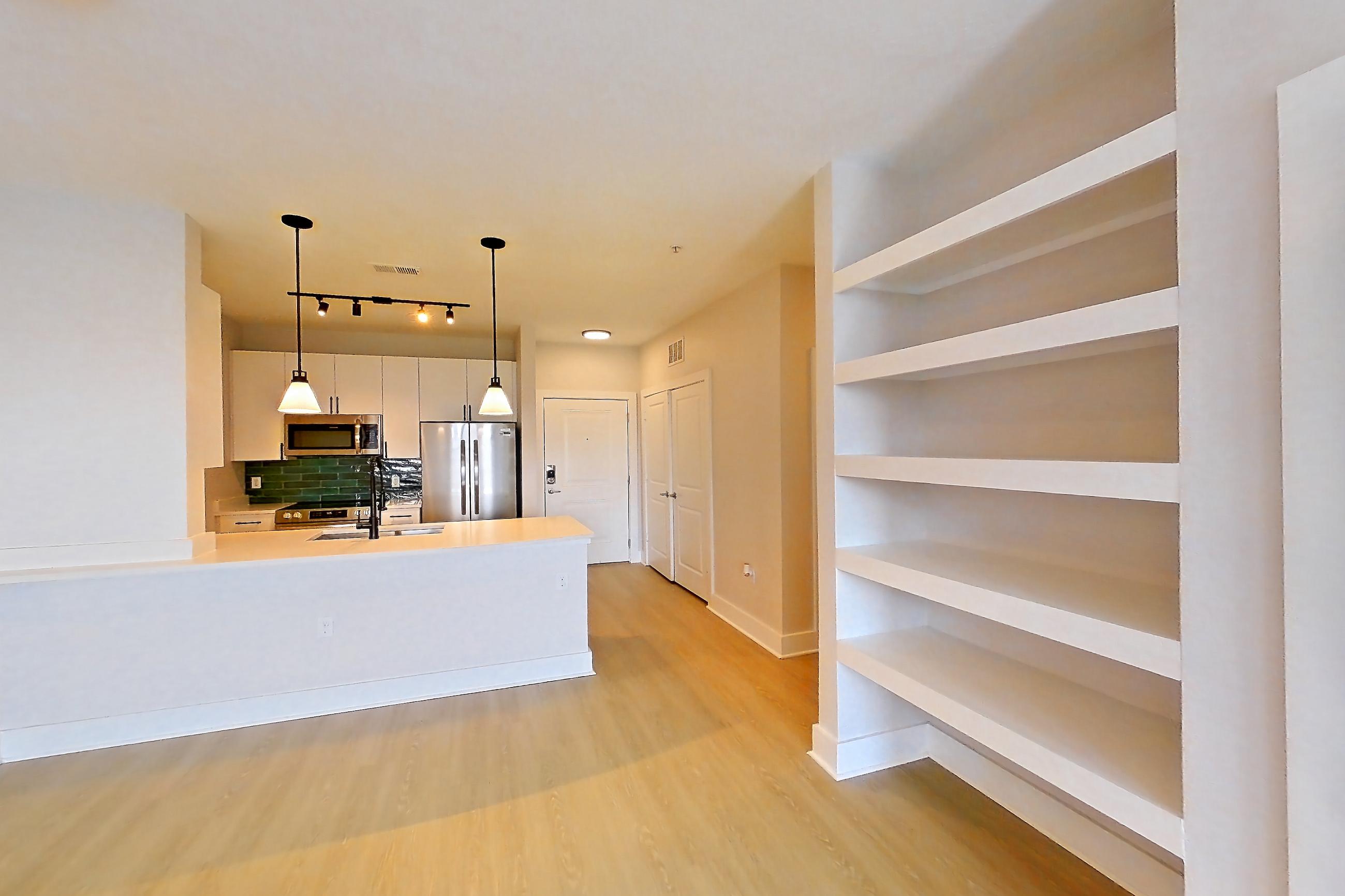 Living room with electric range, oven/range, and stainless steel appliances, Apartment 4411 at NoHo Flats