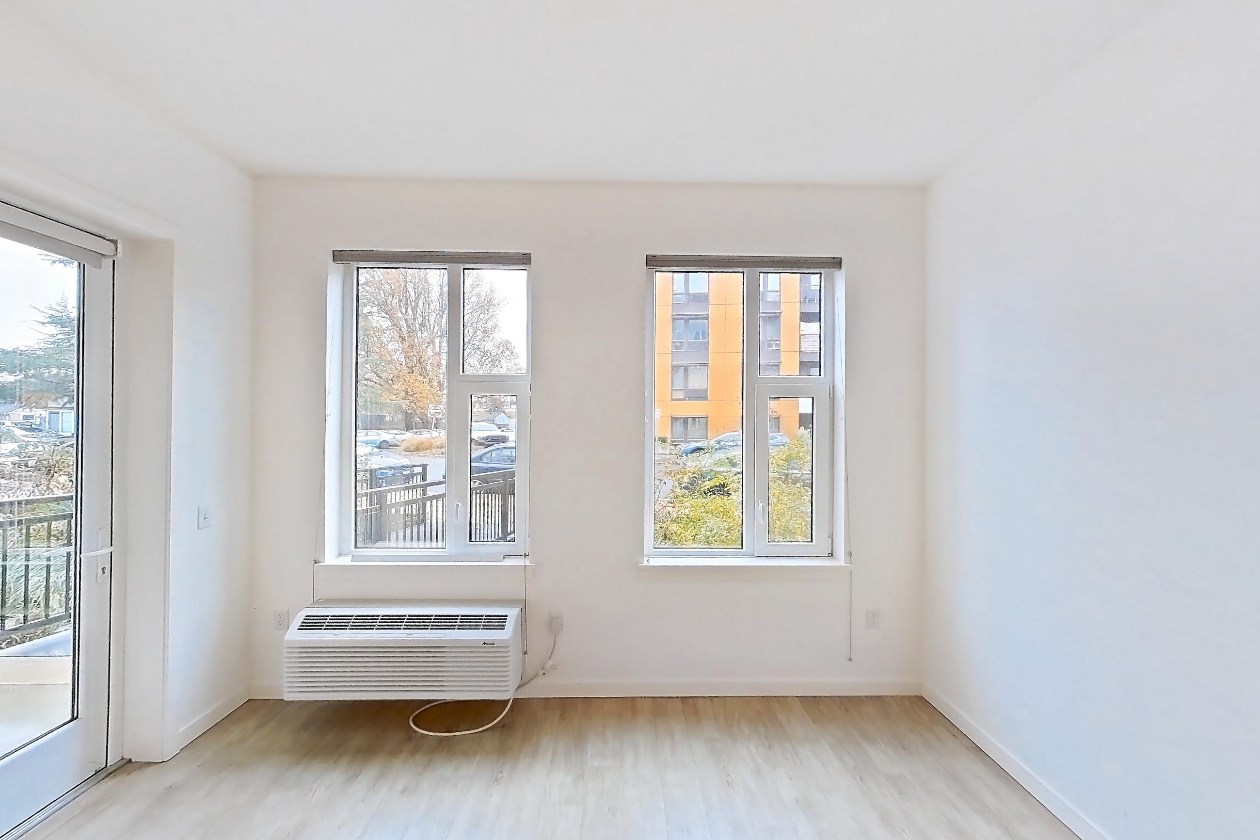 Living room with air conditioning, light vinyl flooring, light wood-finish flooring, and vinyl tile flooring, Apartment 122 at Verso