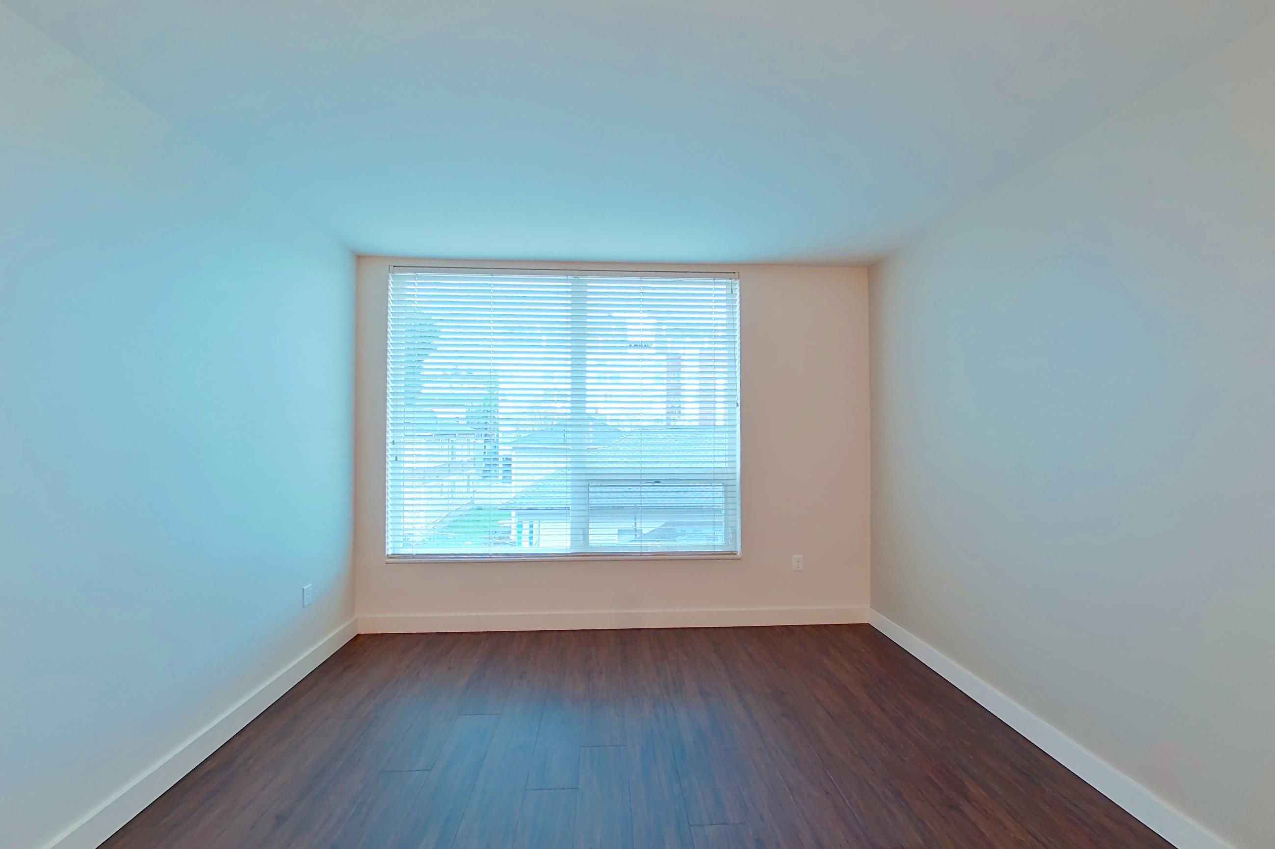 Living room with dark wood-finish flooring, Apartment 405 at Anthem on 12th