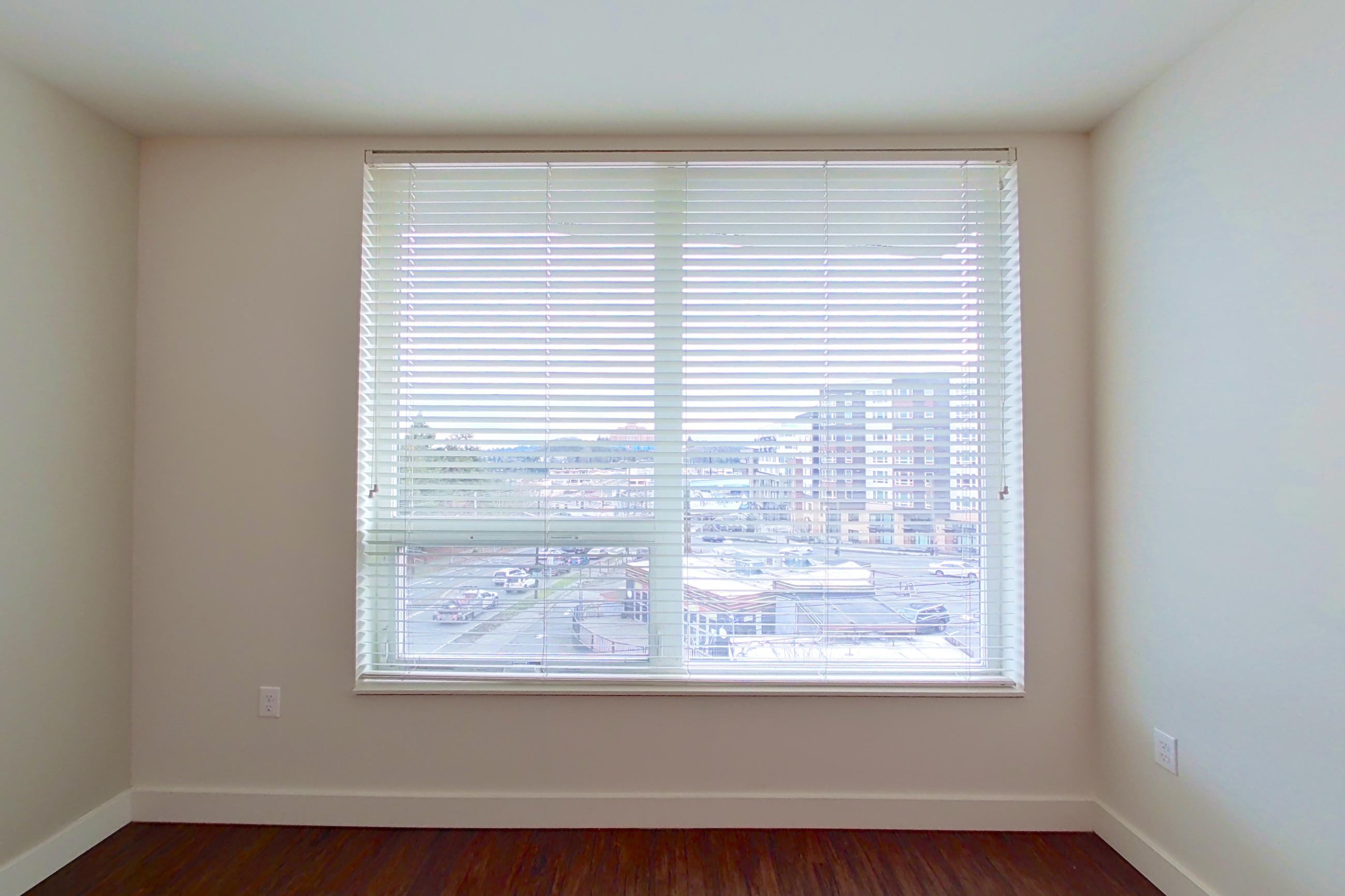Living room with dark wood-finish flooring, Apartment 418 at Anthem on 12th