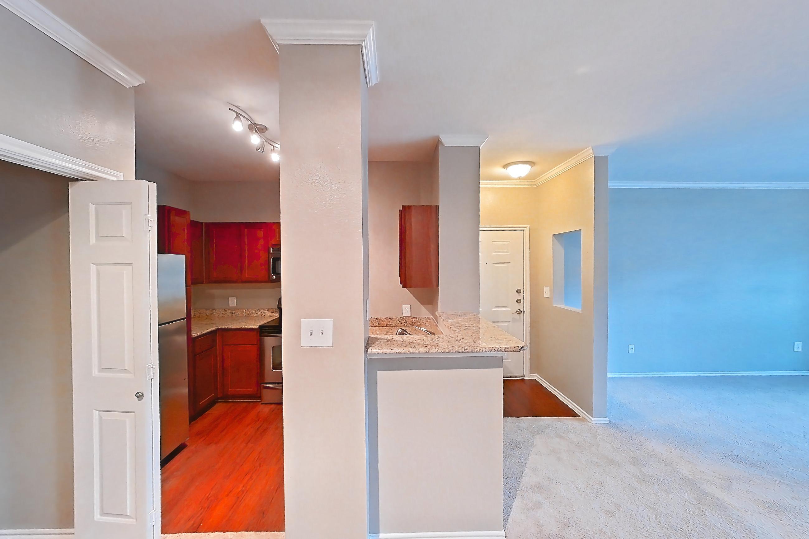 Dining room with light carpet, oven/range, refrigerator, and stainless steel appliances, Apartment 0214 at Marquis at Barton Trails I