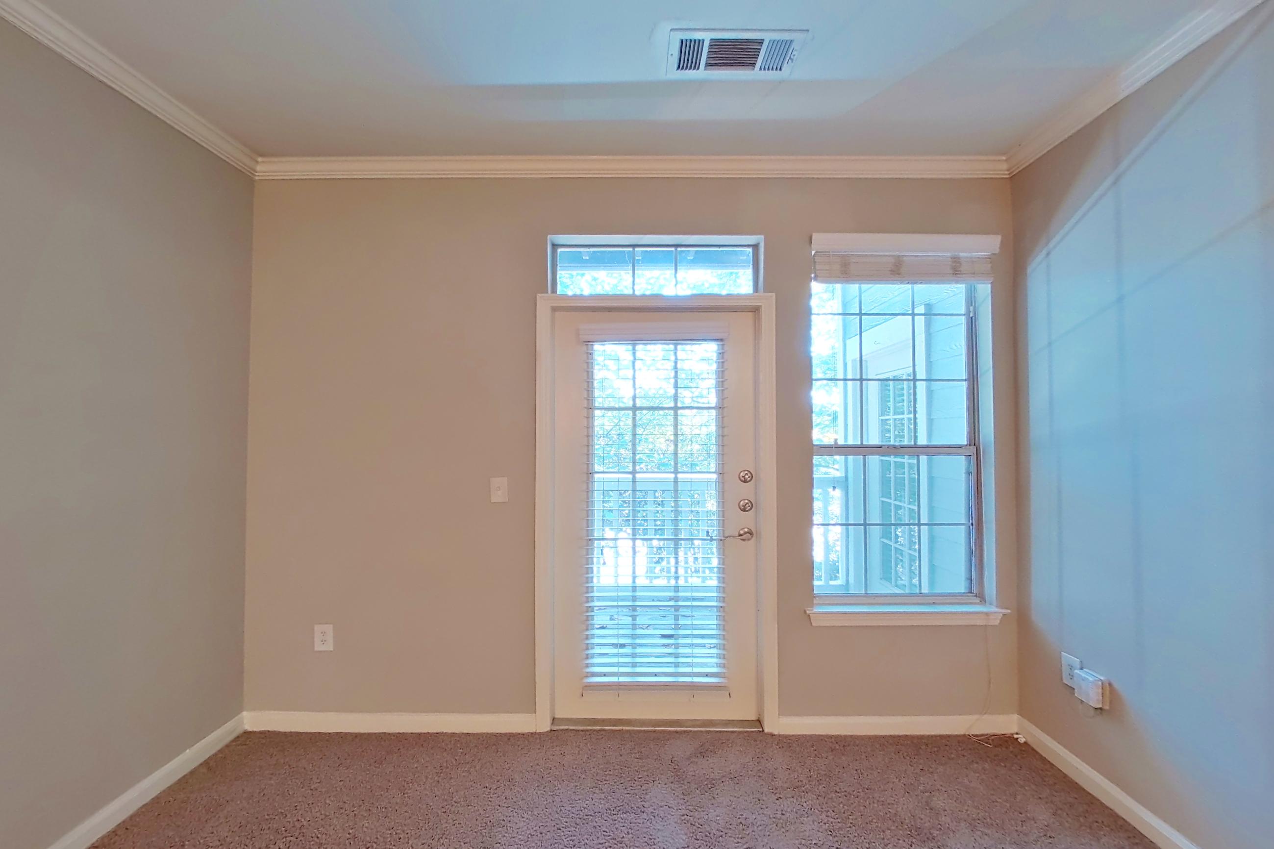 Living room with light carpet and light tile flooring, Apartment 0120 at The Marq at Brookhaven