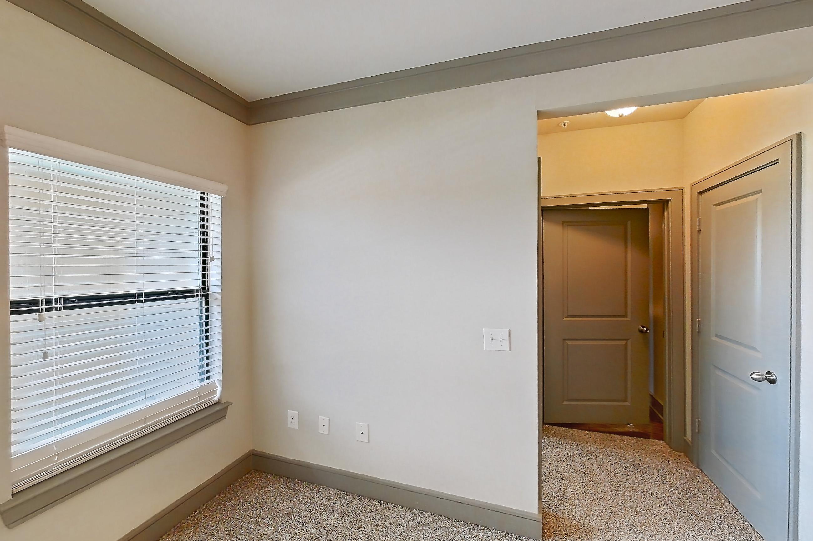 Living room with dark carpet, electric range, oven/range, refrigerator, and stainless steel appliances, Apartment 1210 at Marquis Seven Meadows