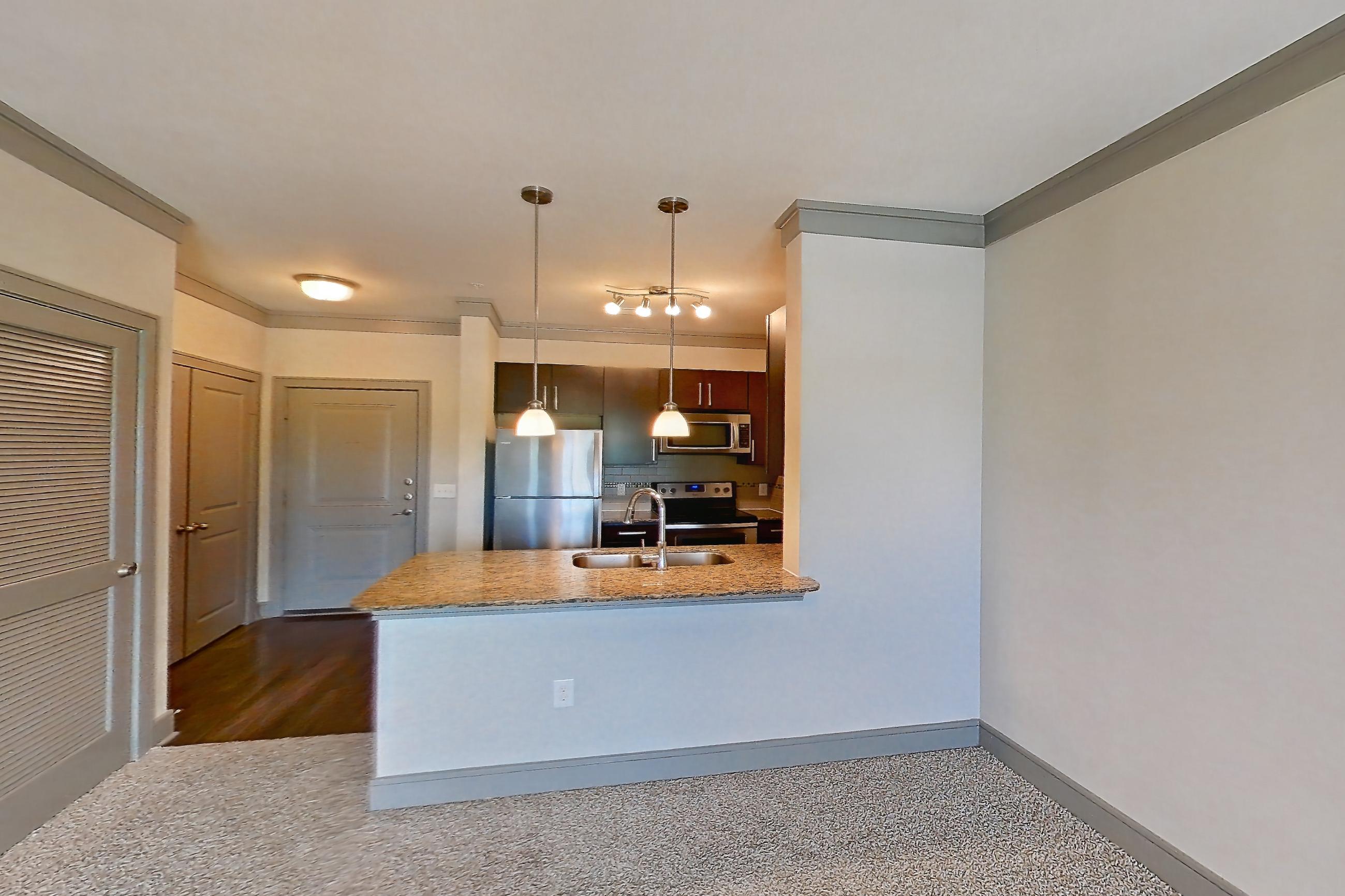 Living room with dark carpet, electric range, oven/range, refrigerator, and stainless steel appliances, Apartment 1210 at Marquis Seven Meadows