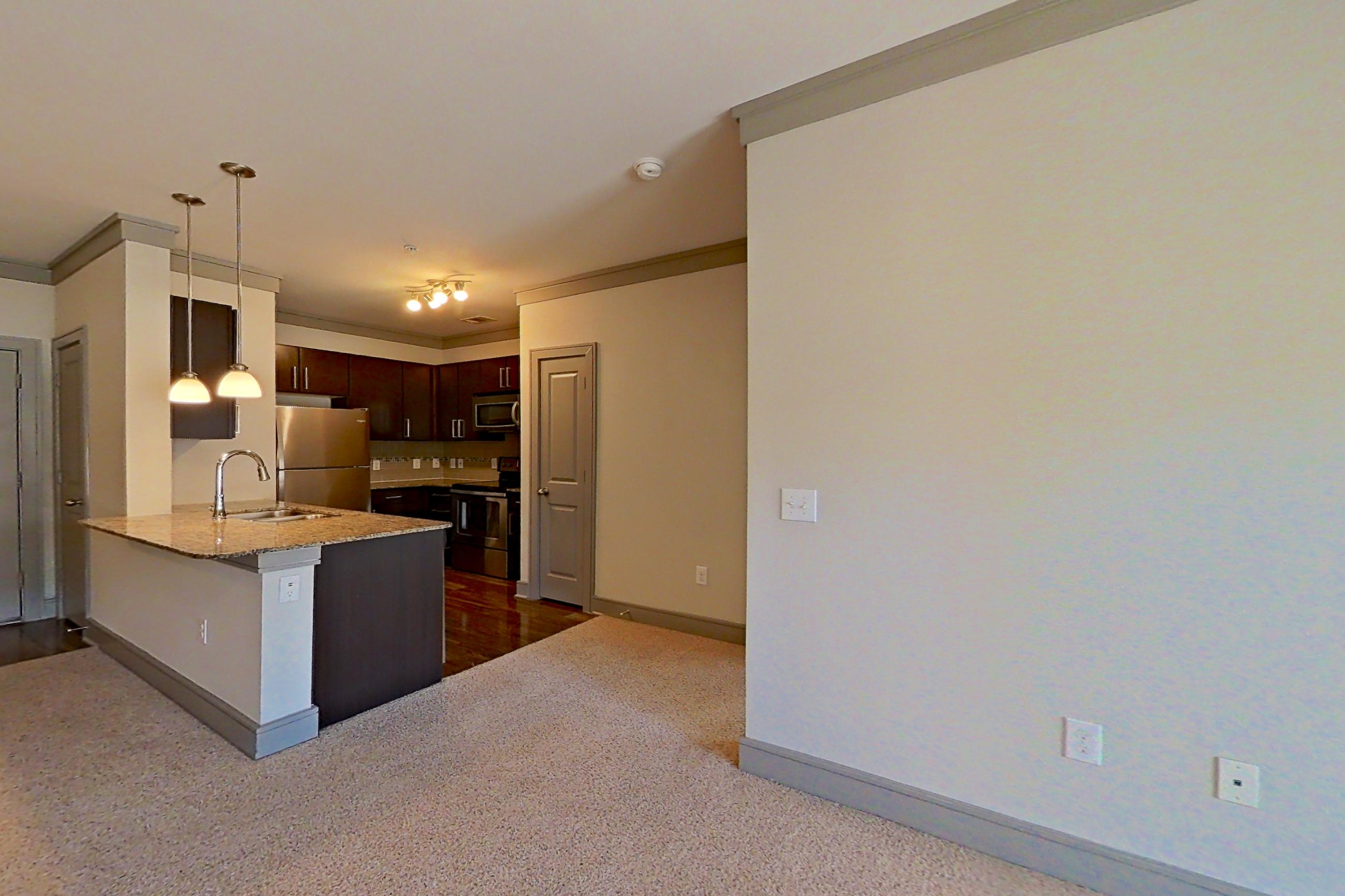 Living room with light stone countertops, Apartment 3309 at Marquis Seven Meadows