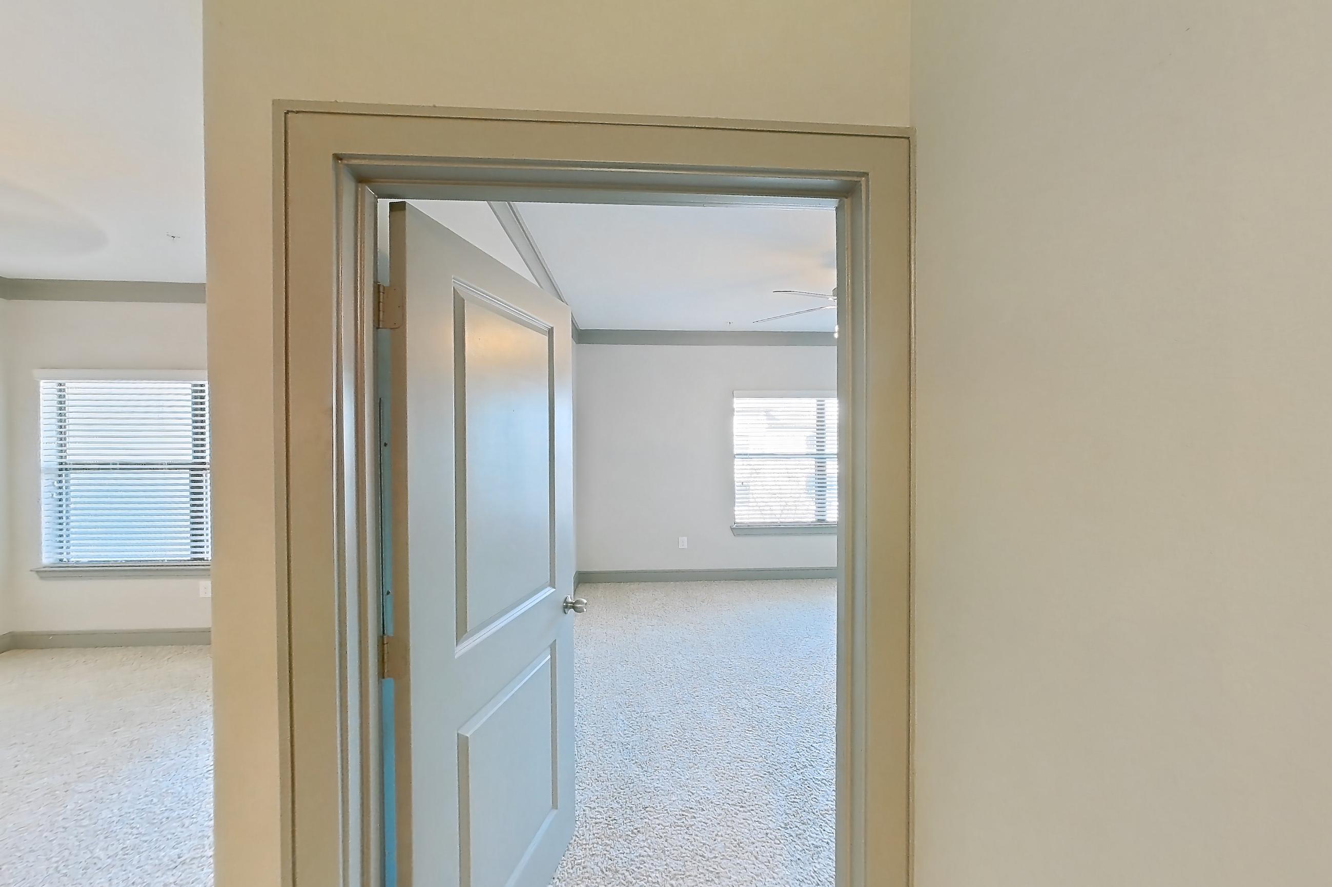 Kitchen space with dishwasher, light carpet, light stone countertops, light wood-finish flooring, and stainless steel appliances, Apartment 3312 at Marquis Seven Meadows