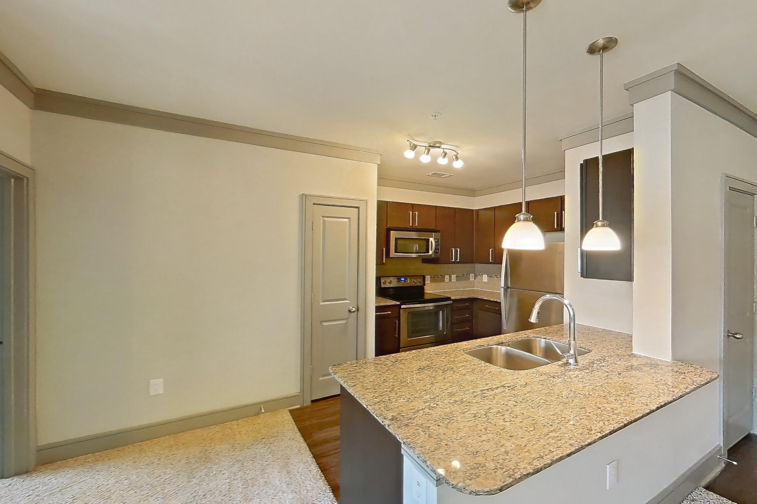 Living space with electric range, light carpet, light stone countertops, oven/range, and stainless steel appliances, Apartment 3312 at Marquis Seven Meadows
