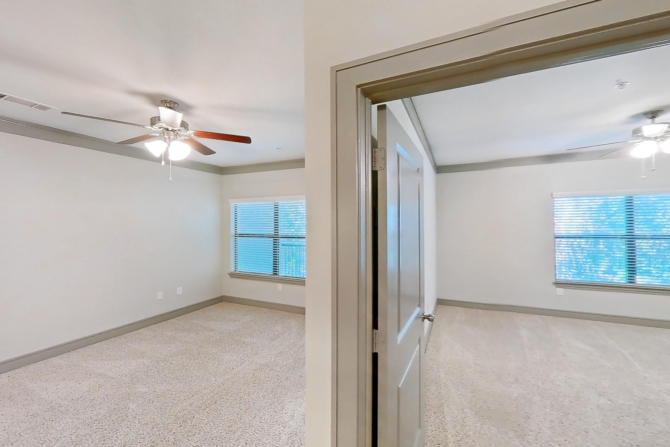 Kitchen space with dark wood-finish flooring, dishwasher, light countertops, light stone countertops, oven/range, refrigerator, and stainless steel appliances, Apartment 4201 at Marquis Seven Meadows