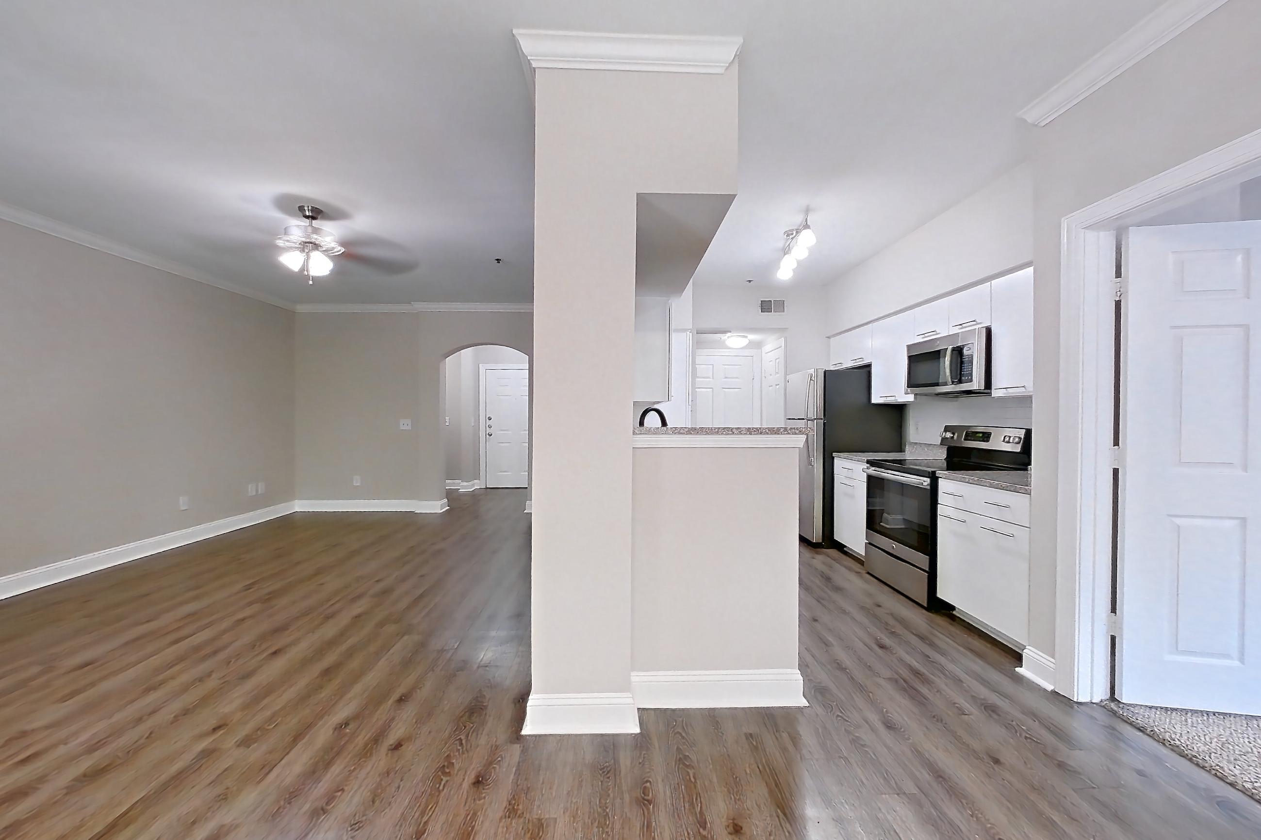 Dining room with electric range, microwave, oven/range, and stainless steel appliances, Apartment 3401 at Marq Perimeter