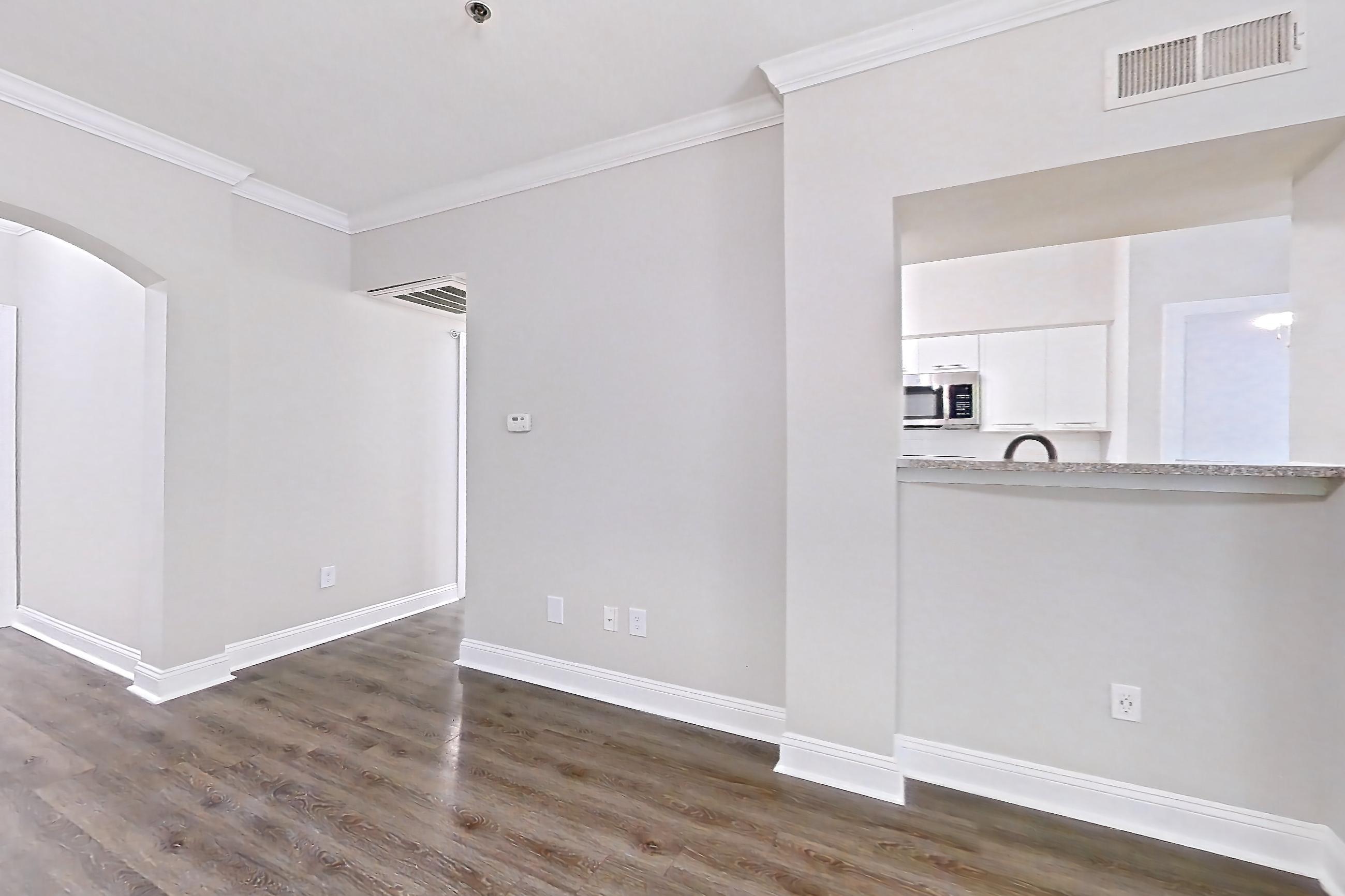 Living room with microwave and stainless steel appliances, Apartment 3401 at Marq Perimeter